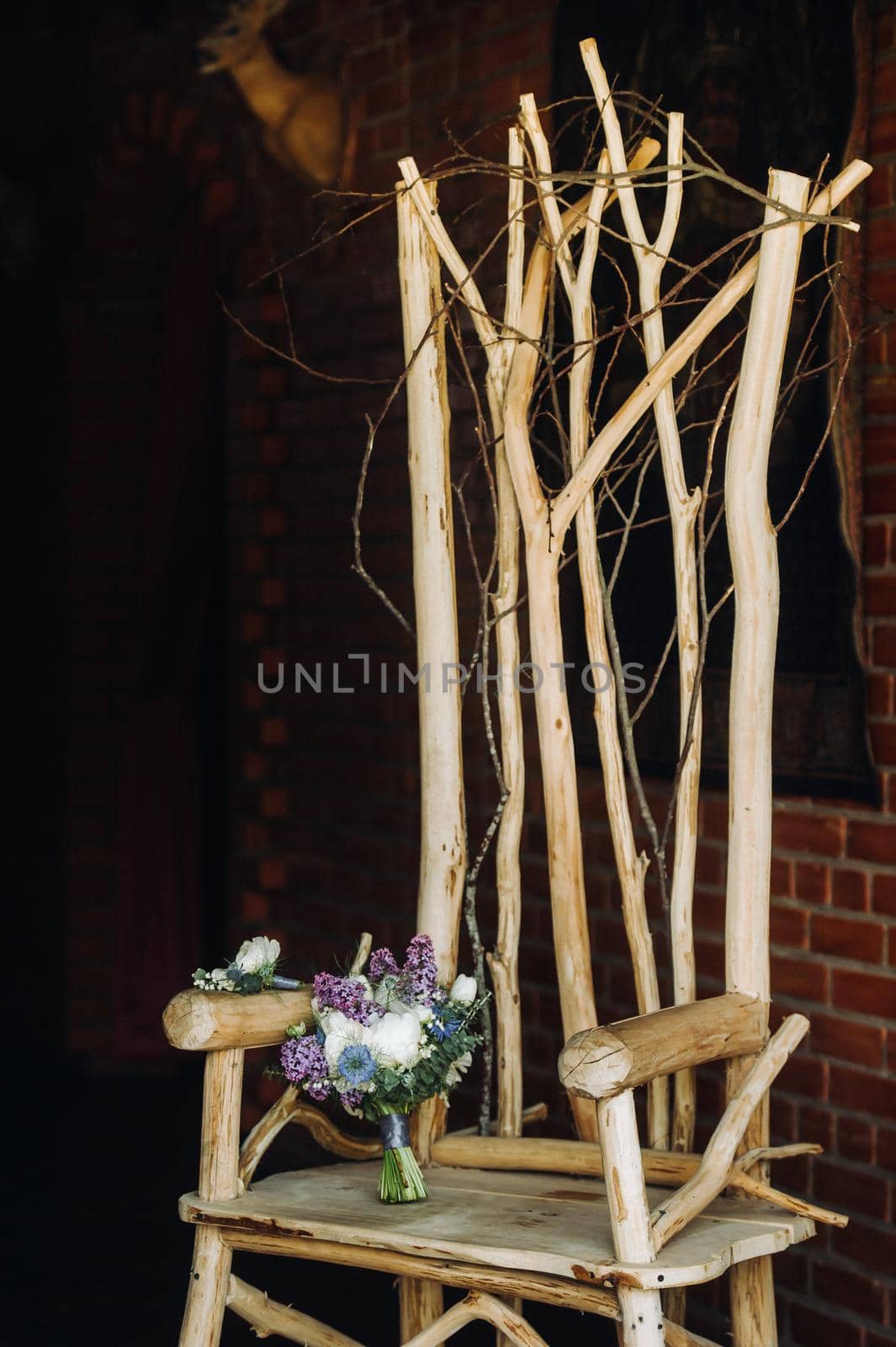 a spring Wedding bouquet of lilac and white roses lies on a decorative wooden chair.Wedding bouquet, details, wedding, decor.