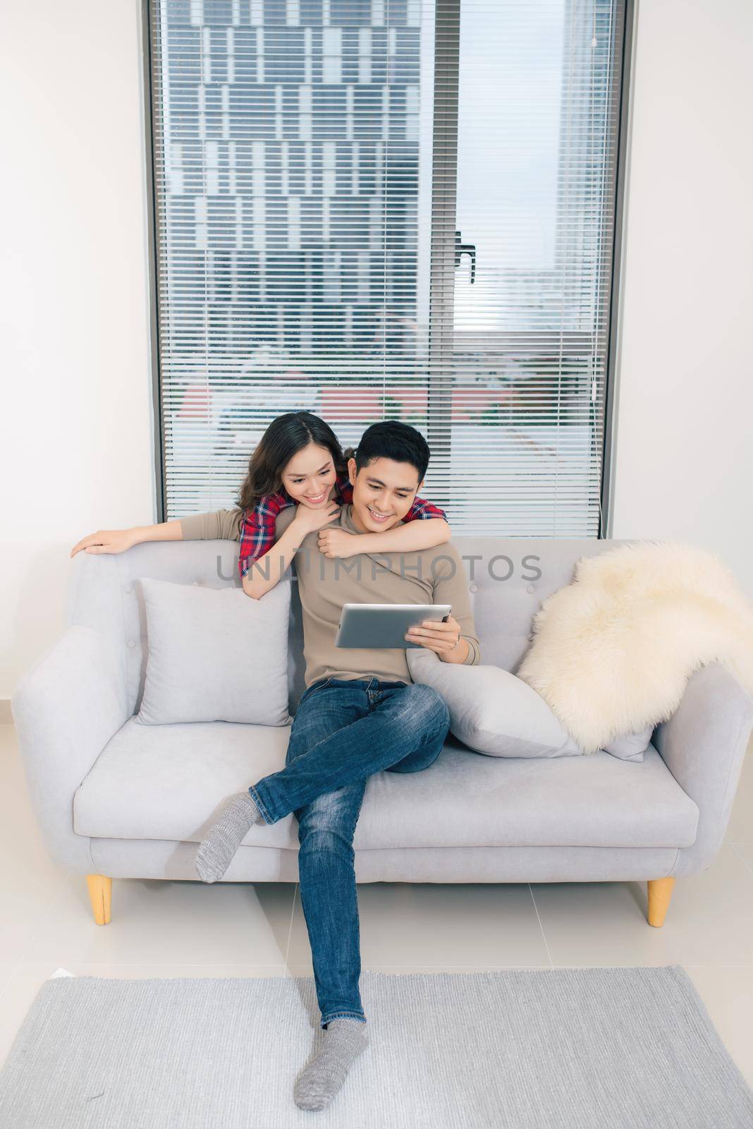 Just married couple of young man and woman feeling unbelievable chilling in their new house
