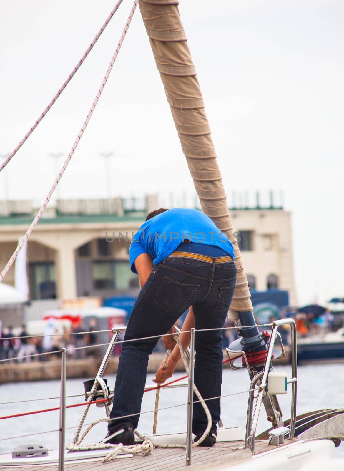 TRIESTE, ITALY - OCTOBER, 12: The crew of sailboat haul down the sails during the 46° Barcolana regatta in Trieste sea on October 12, 2014