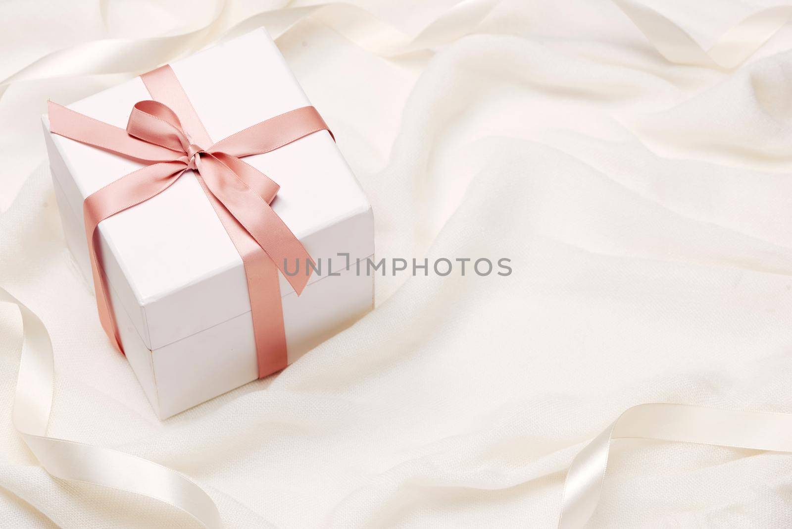 Romantic gift. Present on white silk background. by makidotvn