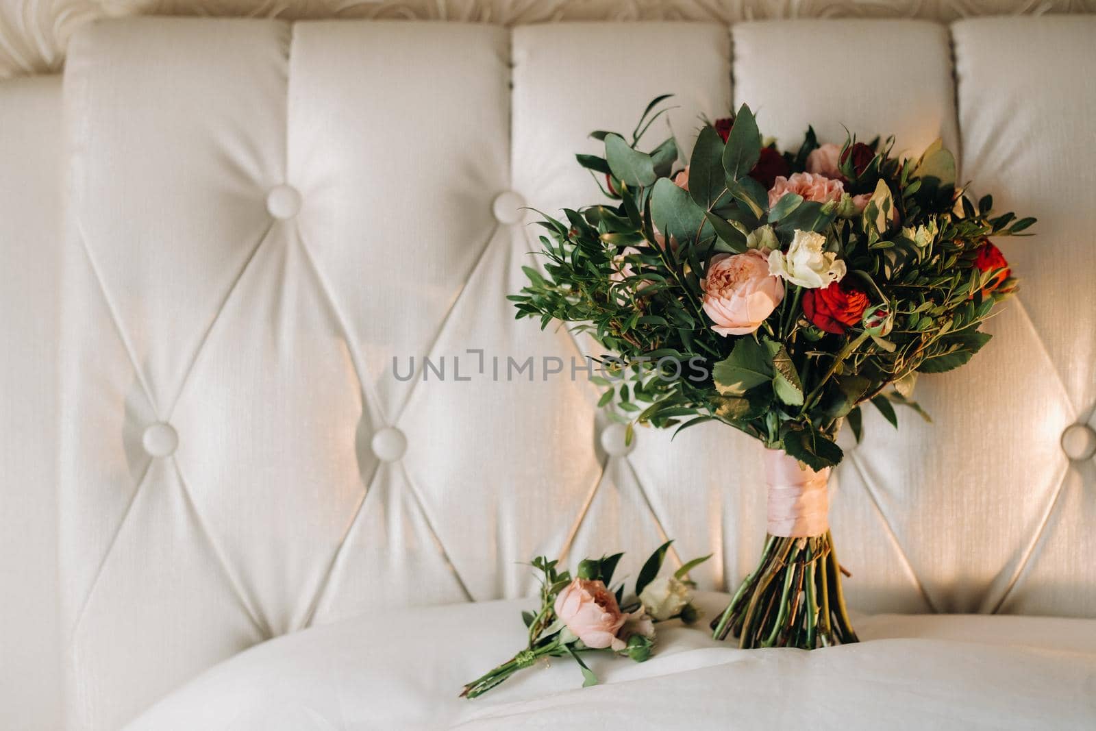 wedding bouquet with roses and boutonniere.The decor at the wedding.