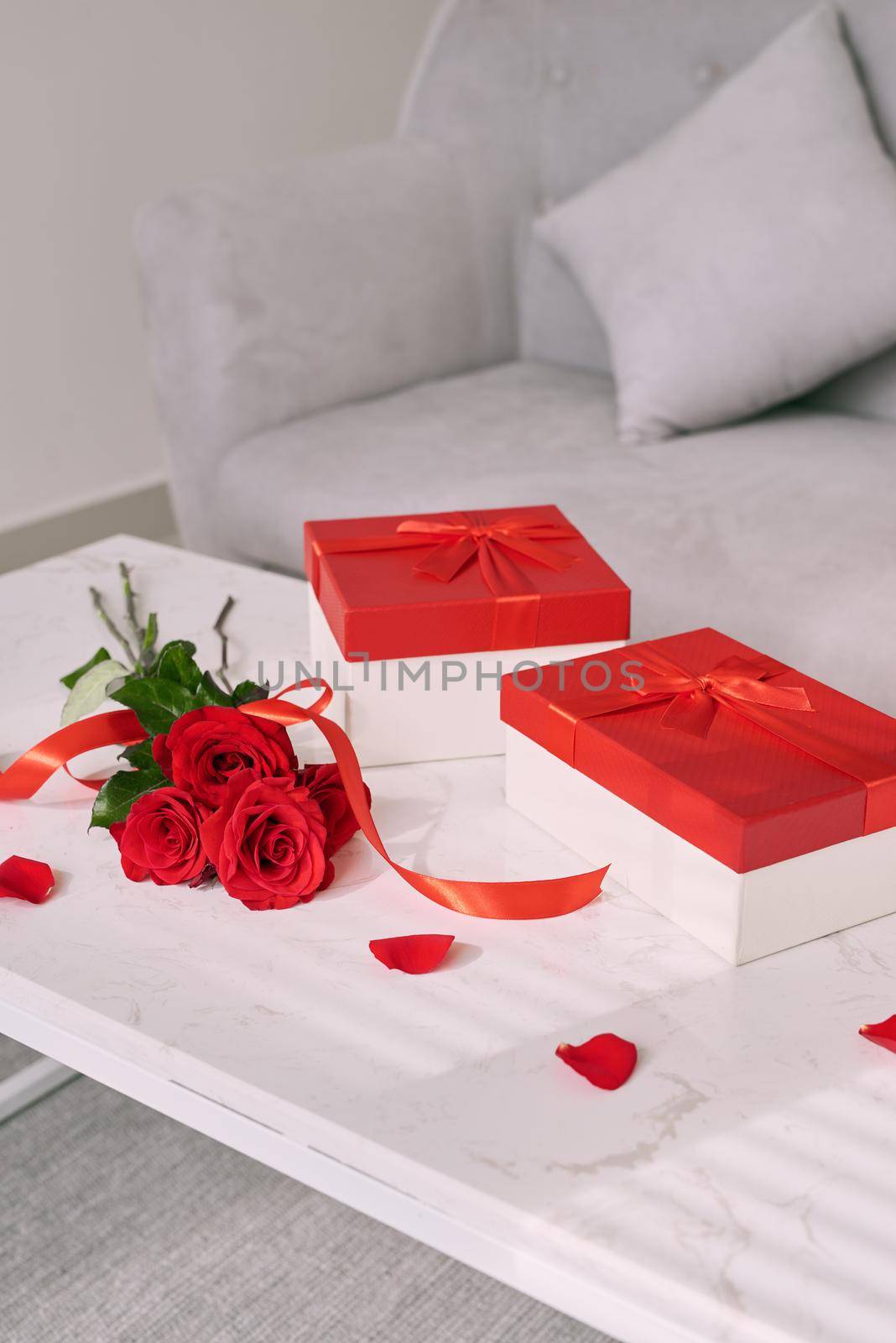 Mothers Day gifts and red rose on table.