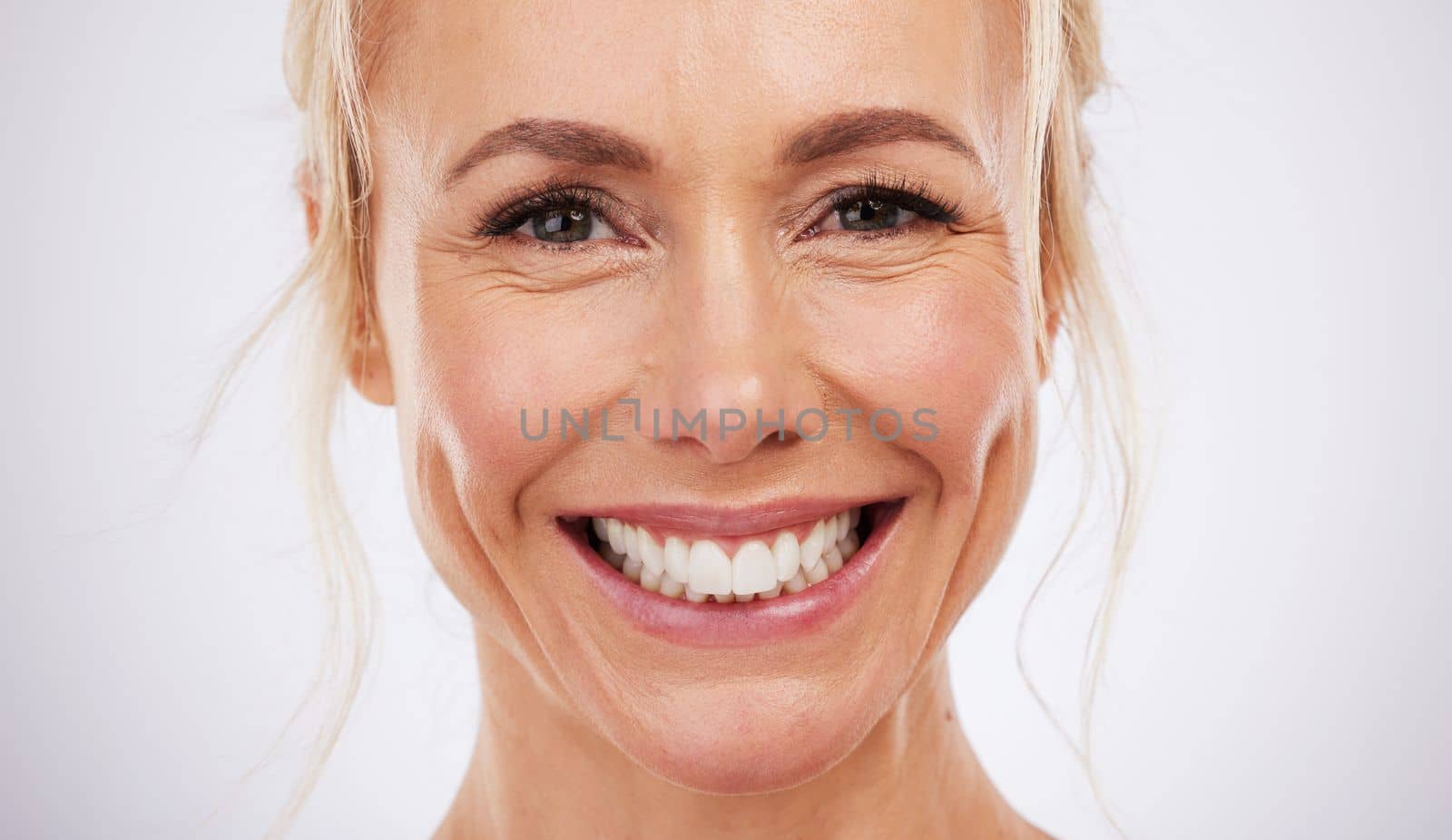 Teeth whitening, portrait and smile of woman in studio, beauty background and fresh mint breath. Happy female model, face and skincare for dental wellness, tooth implant and aesthetic facial salon by YuriArcurs