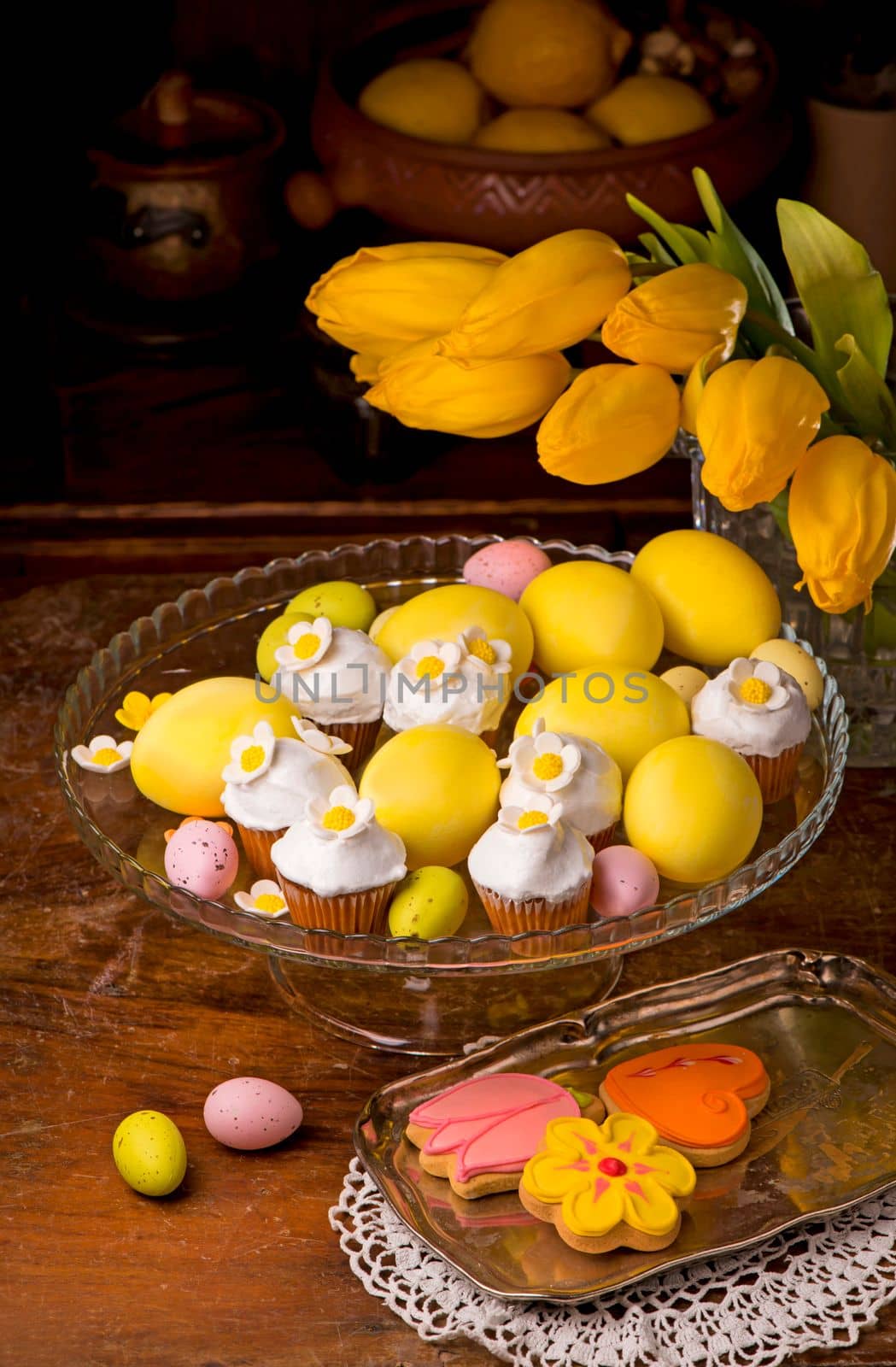 Easter eggs, flowers and muffins. Little cupcake with sugar decorations for easter by aprilphoto