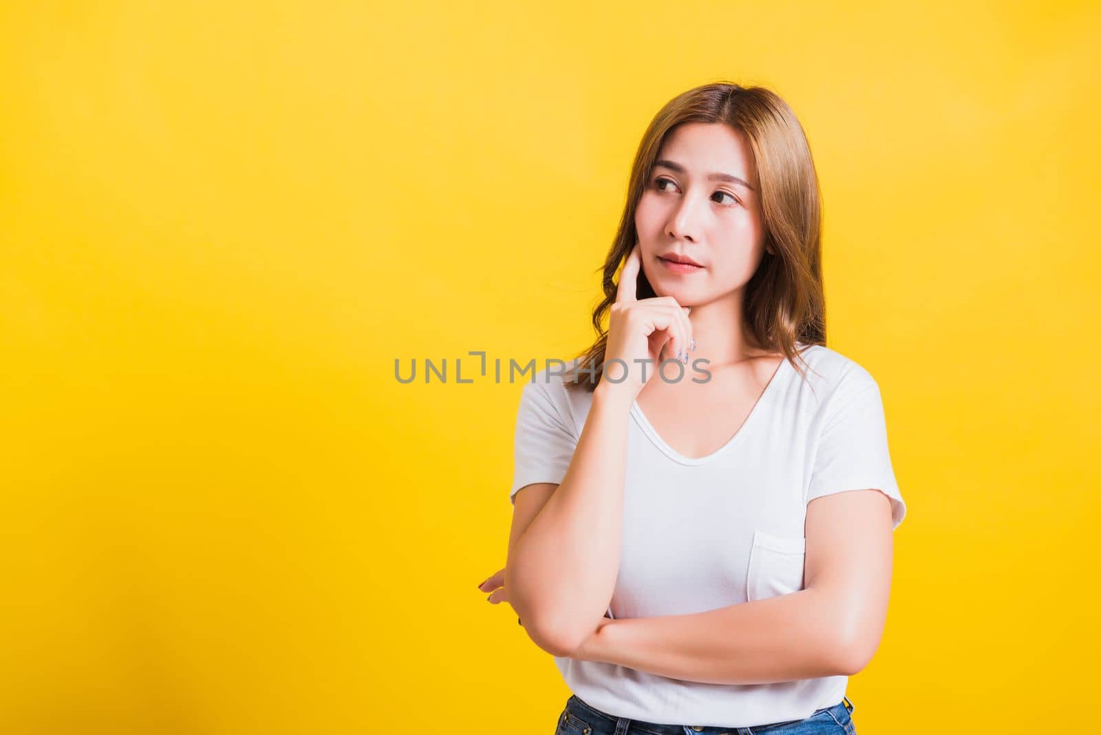 woman smile wear white t-shirt standing relaxed thinking about something about question by Sorapop
