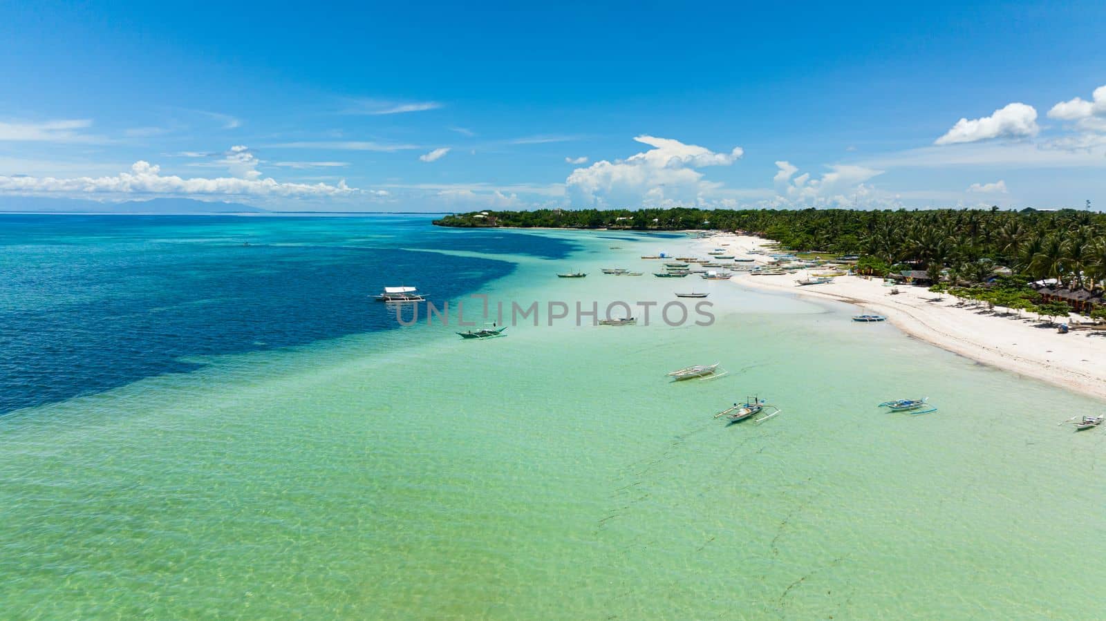 Aerial view of tropical sandy beach with palm trees. Bantayan island, Philippines.