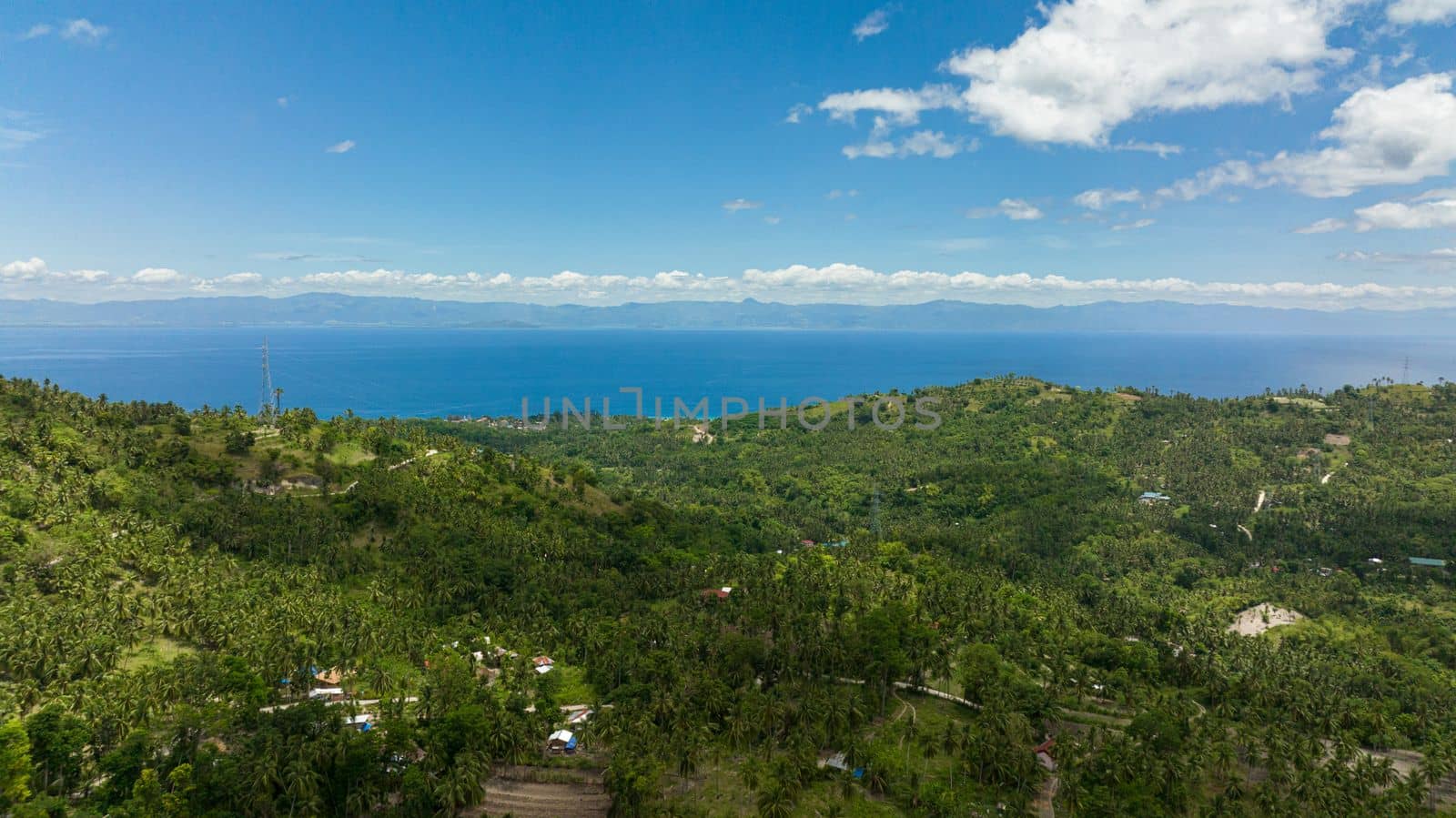 The coastline of the island of Cebu against the backdrop of the blue sea and the island of Negros. Philippines.