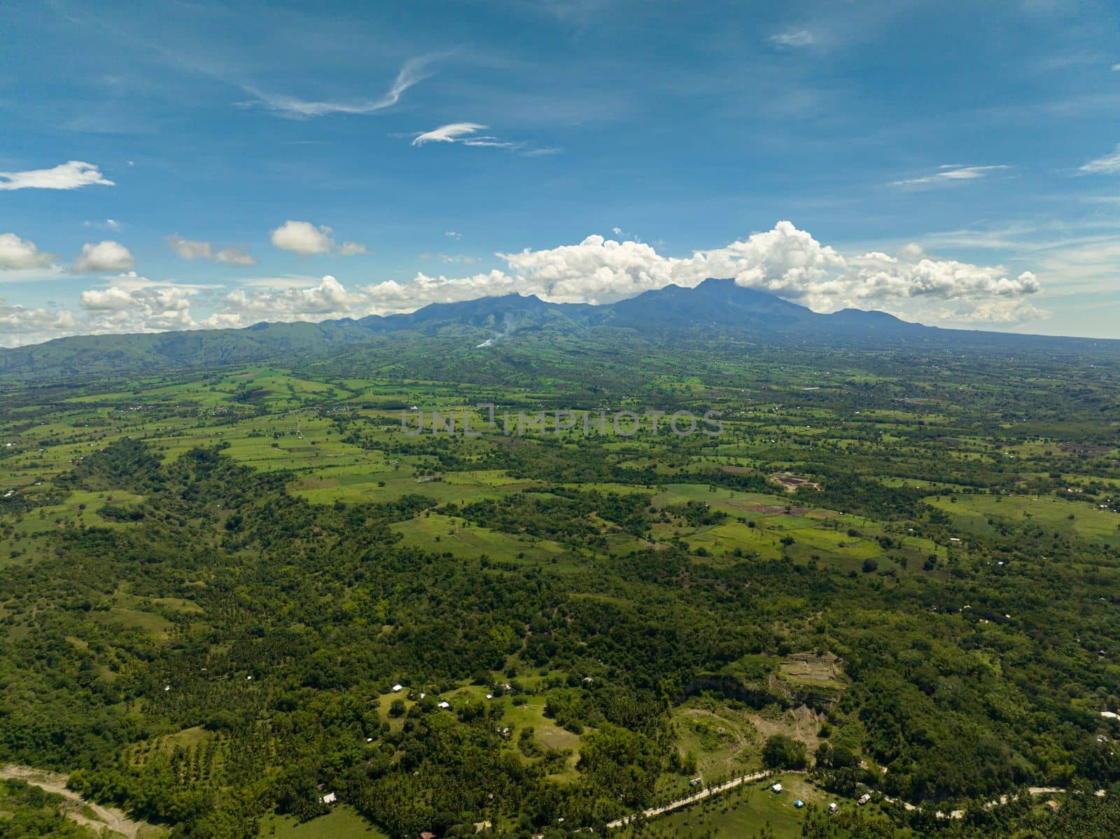Aerial view of valley in the mountains with farmland, rice fields. Negros, Philippines
