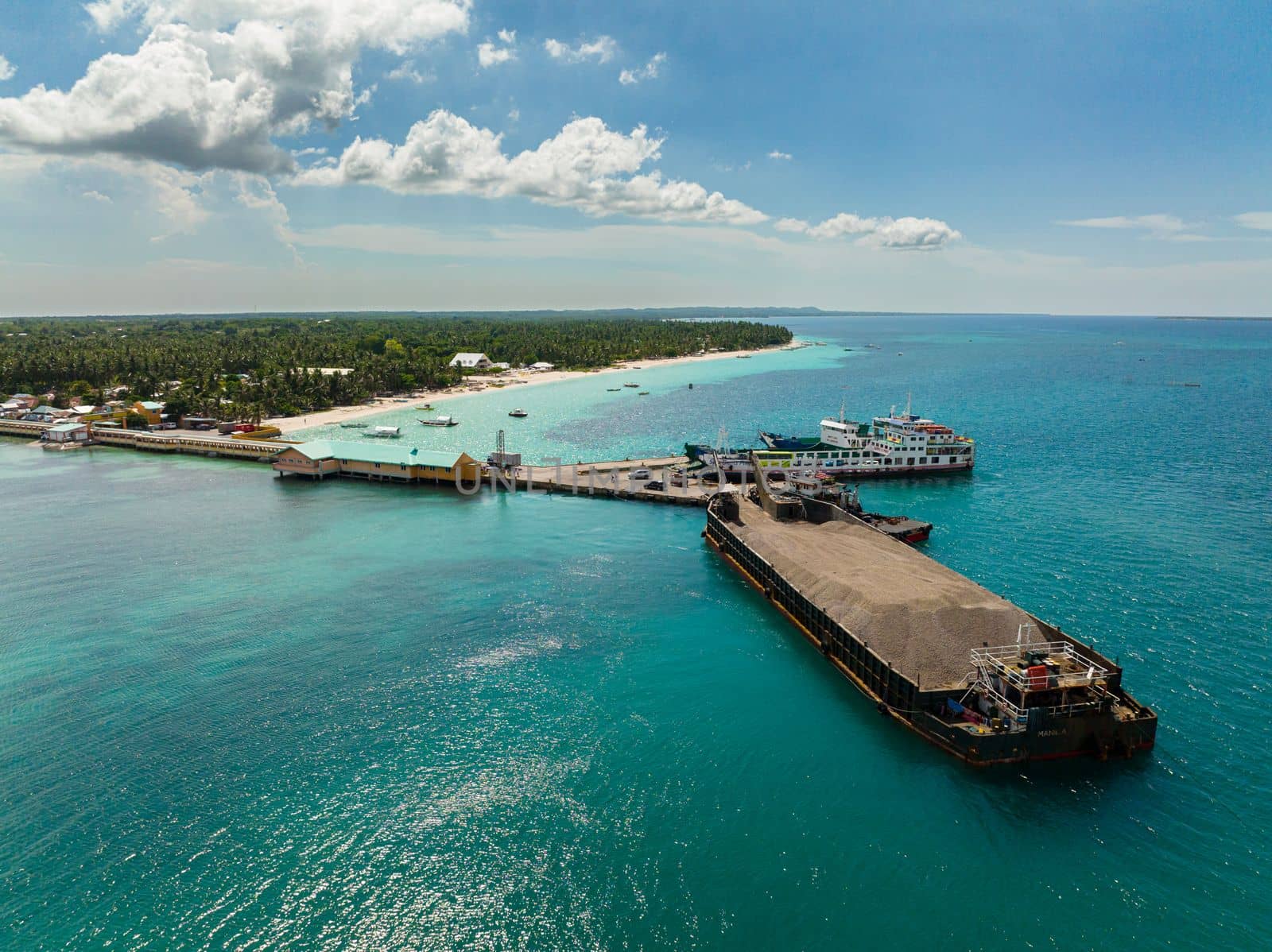 Aerial drone of sea port and ships on a tropical island. Bantayan island, Philippines.