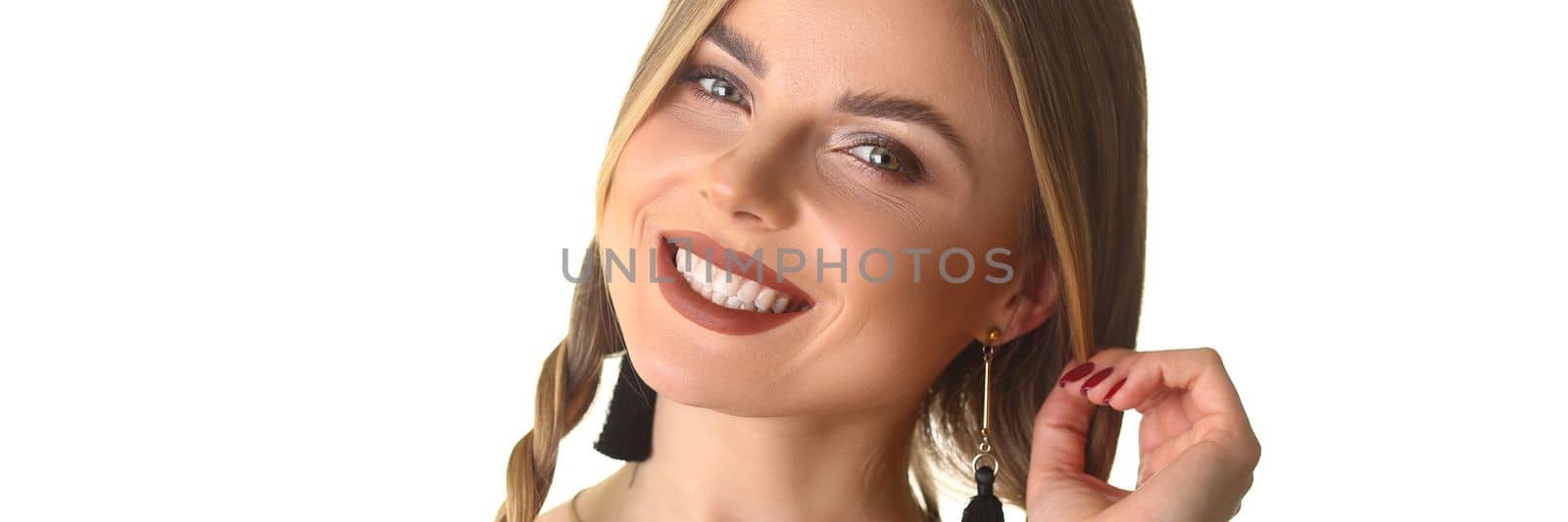 Happy woman with long pigtail and beautiful makeup. Evening stylish makeup concept