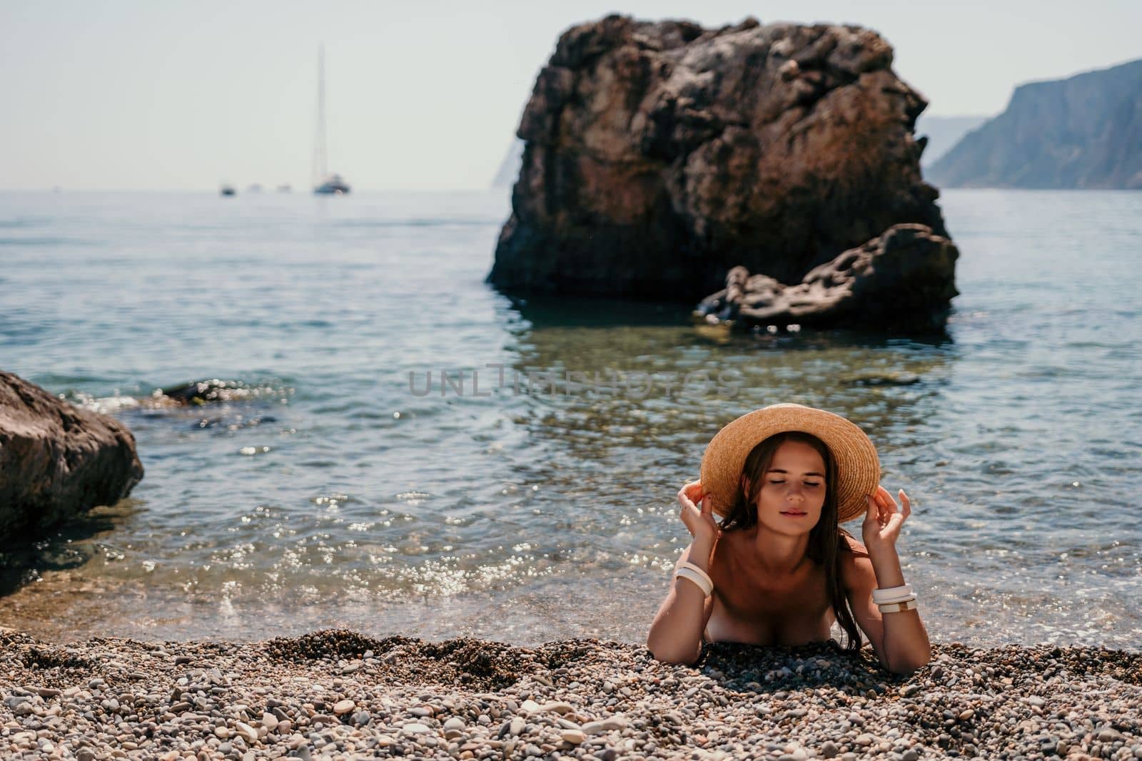 Woman travel sea. Happy tourist in hat enjoy taking picture outdoors for memories. Woman traveler posing on the beach at sea surrounded by volcanic mountains, sharing travel adventure journey by panophotograph