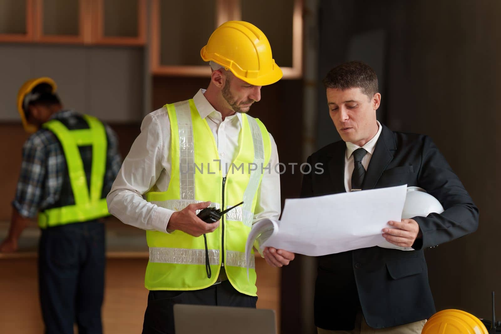 Civil Construction team working at renovate construction site. architectural plan, engineer sketching a construction project, green energy concept