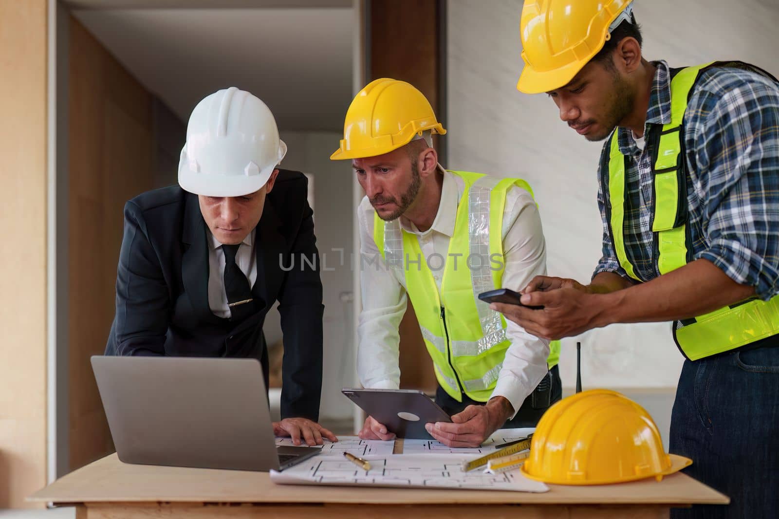 Civil Construction team working at renovate construction site. architectural plan, engineer sketching a construction project, green energy concept. by itchaznong