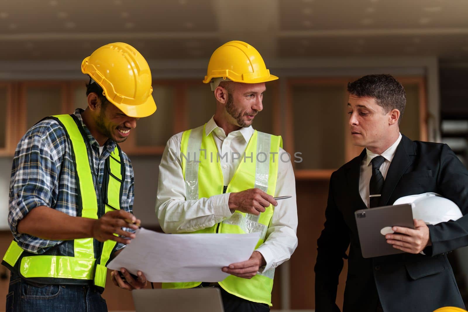 Civil Construction team working at renovate construction site. architectural plan, engineer sketching a construction project, green energy concept. by itchaznong