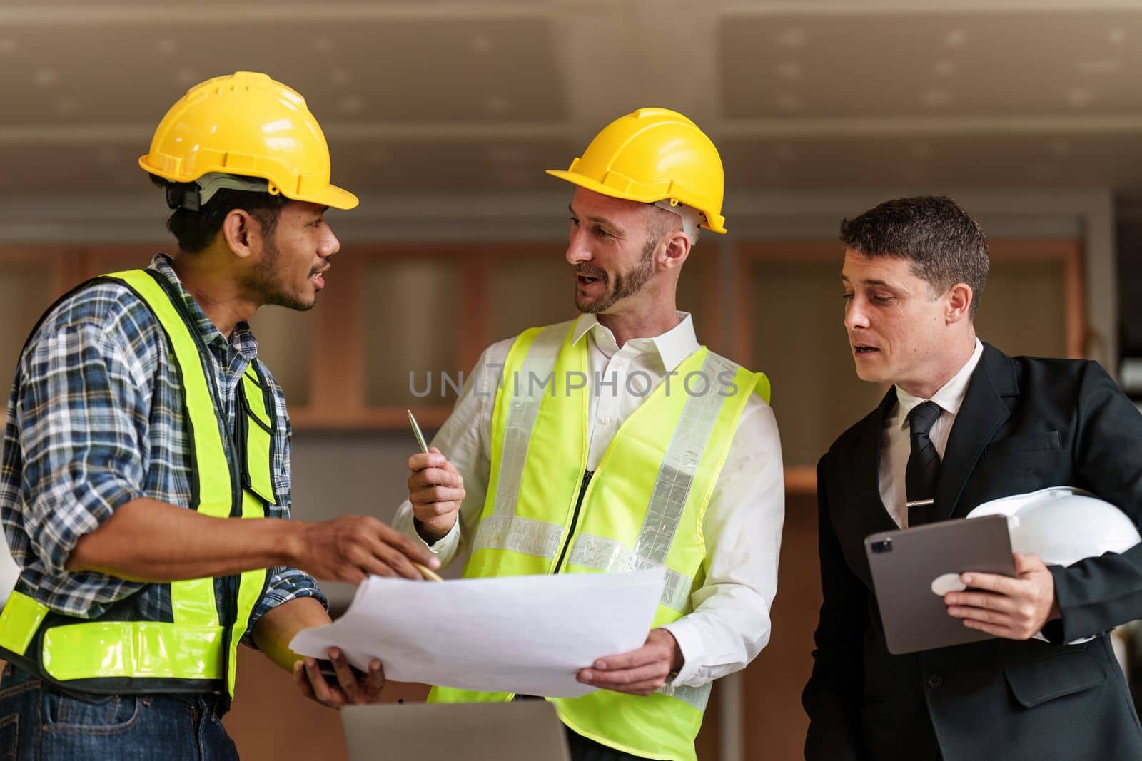 Civil Construction team working at renovate construction site. architectural plan, engineer sketching a construction project, green energy concept. by itchaznong