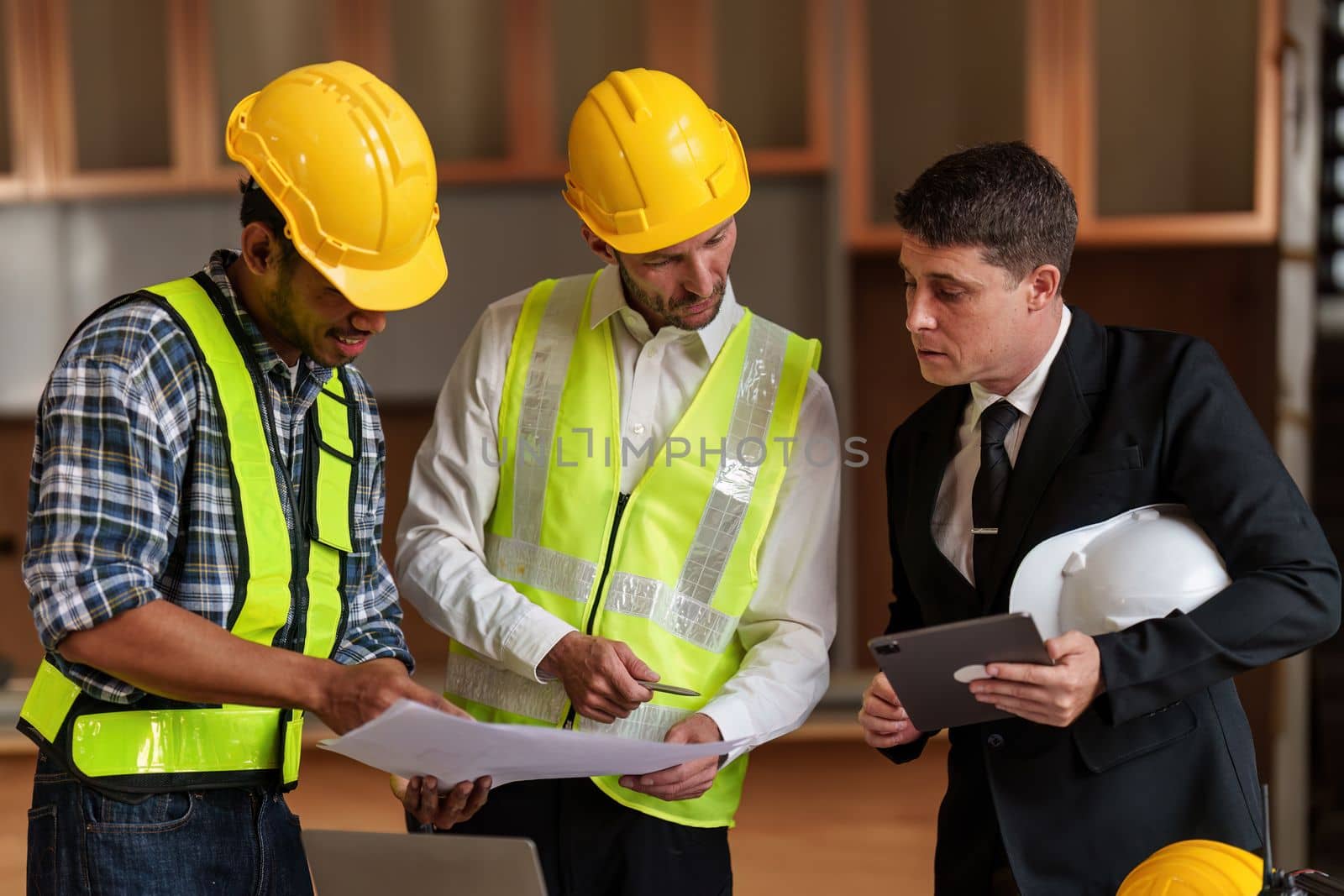 Civil Construction team working at renovate construction site. architectural plan, engineer sketching a construction project, green energy concept. by itchaznong