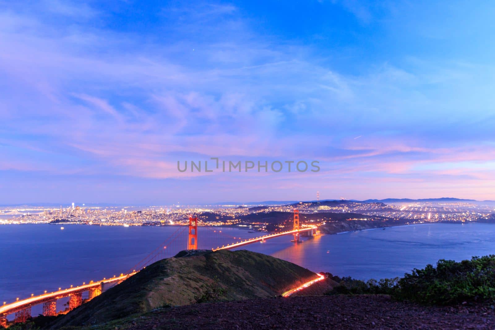 Car lights on Golden Gate Bridge by San Francisco and Pink Clouds at Blue Hour by Osaze