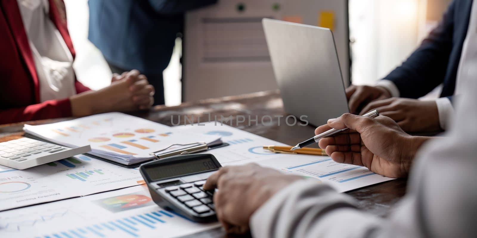 Business People Meeting using laptop computer,calculator,notebook,stock market chart paper for analysis Plans to improve quality next month. Conference Discussion Corporate Concept by nateemee