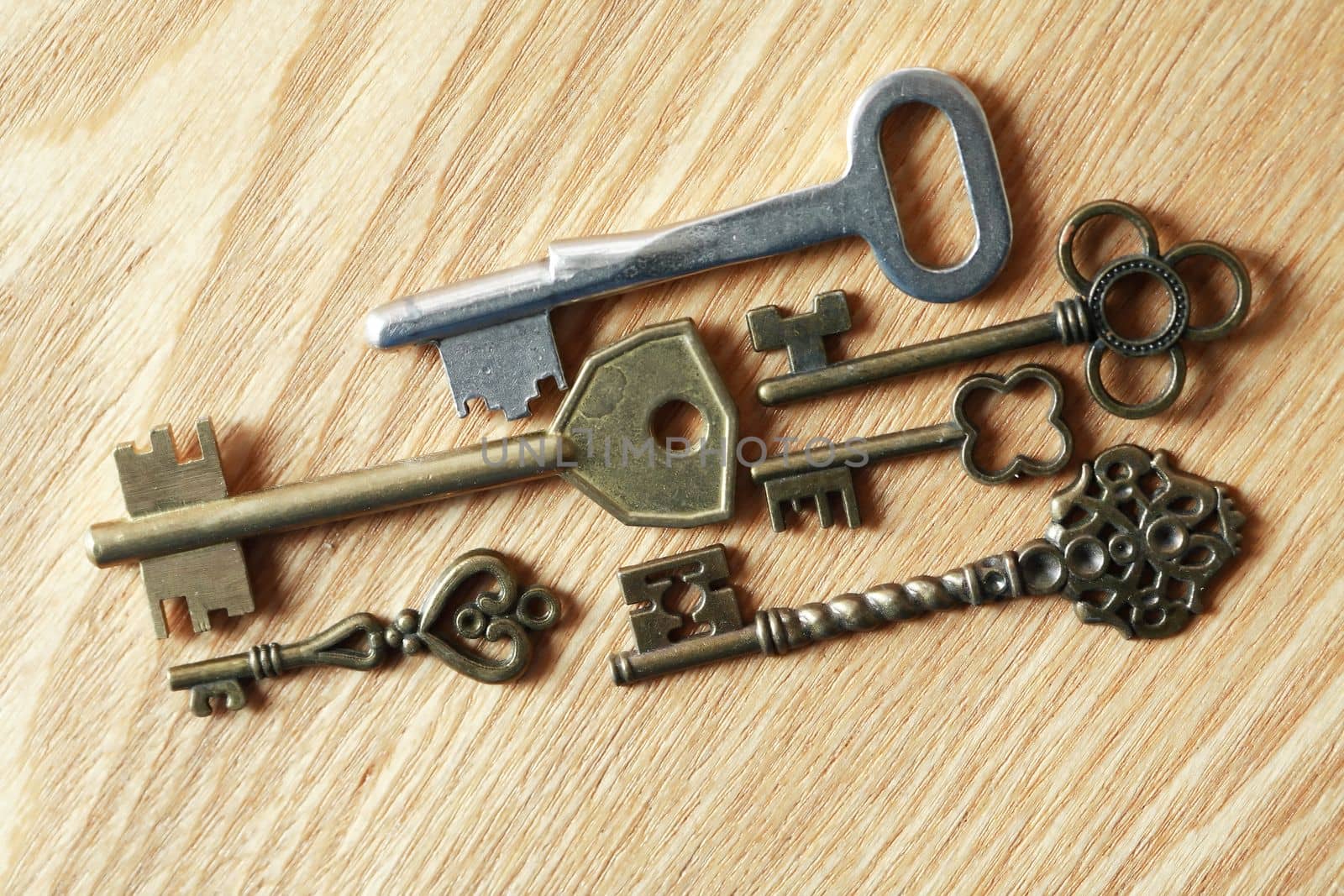 Set of various old keys on wooden surface