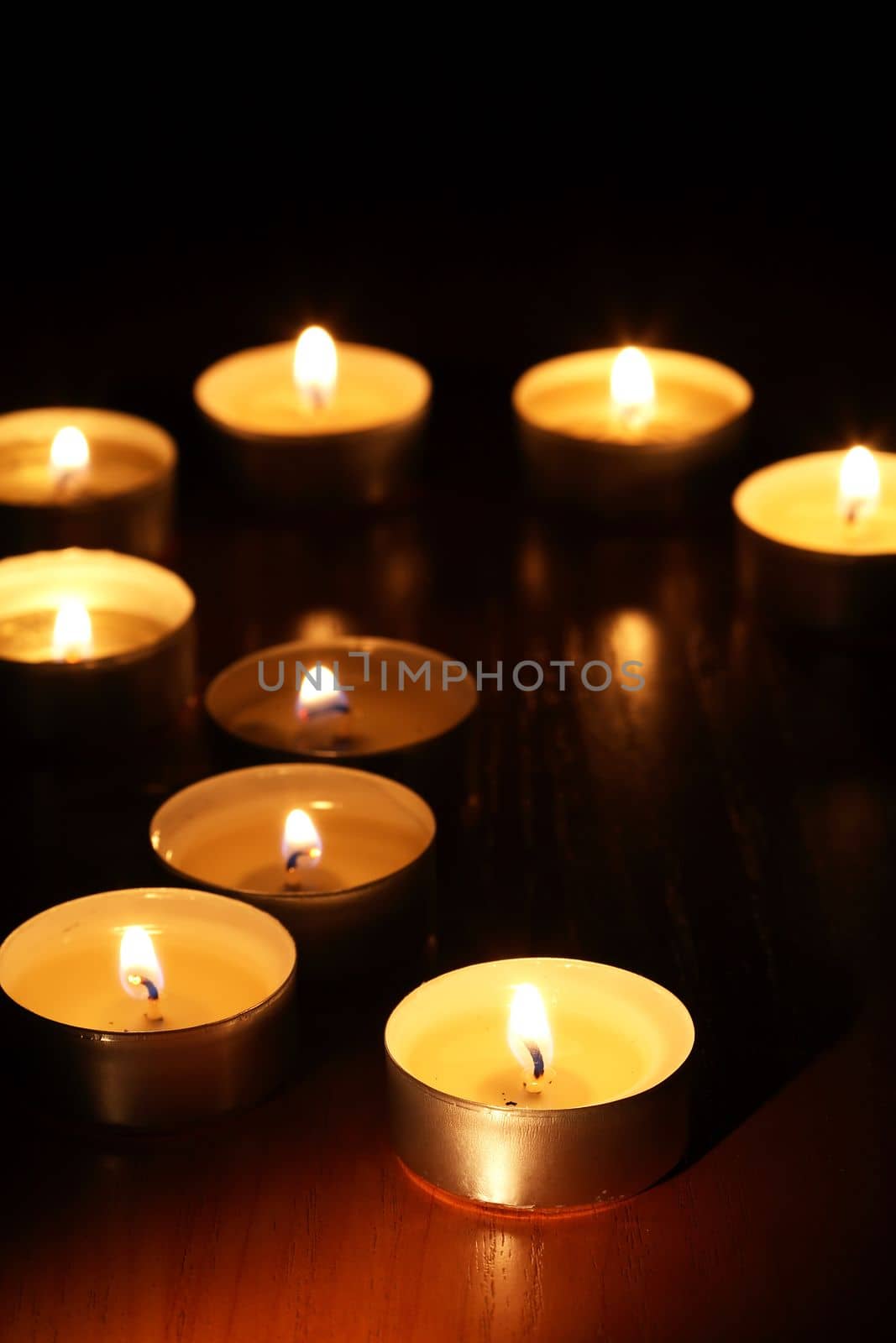 Set of lighting candles on dark background