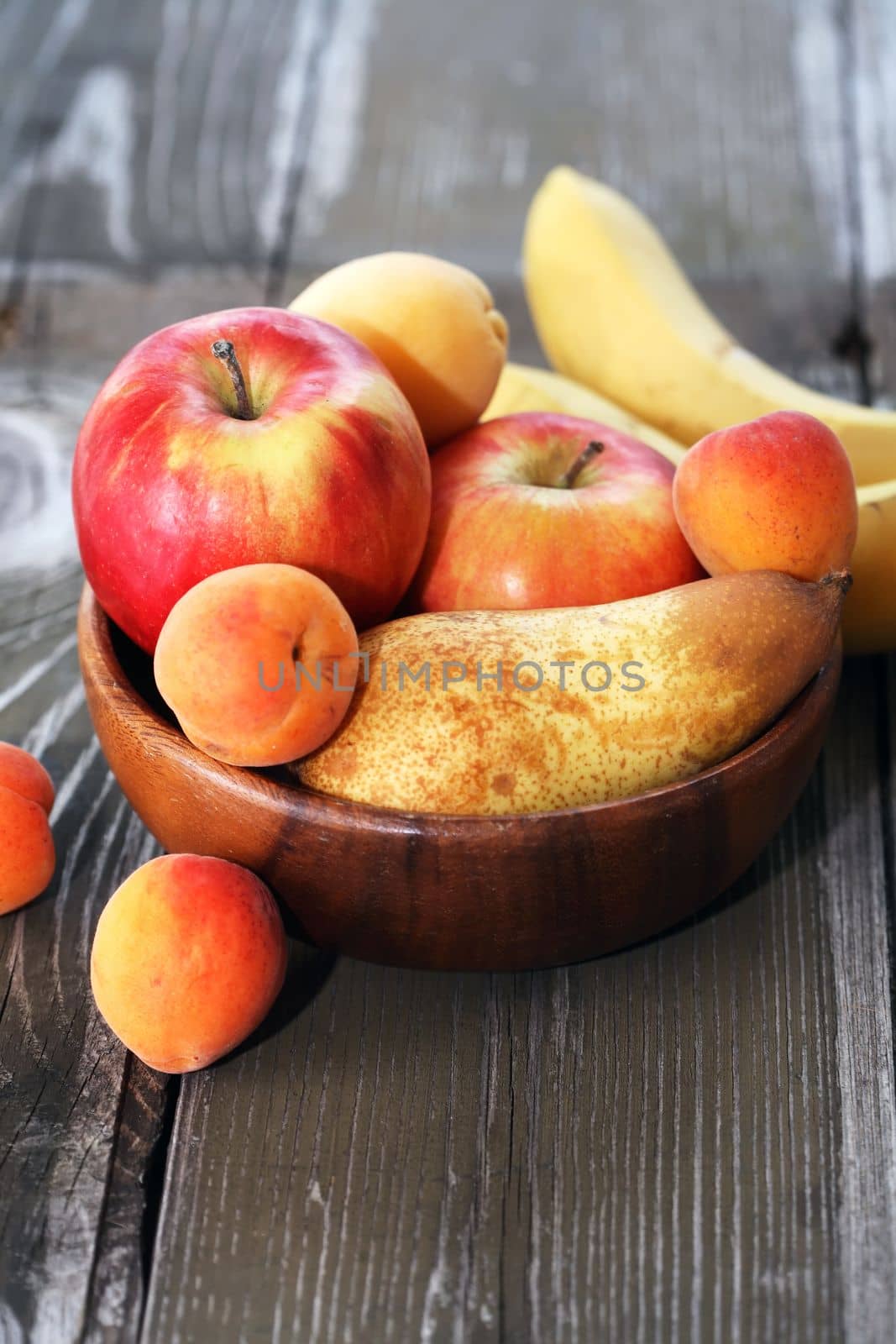 Heap of freshness fruits in  bowl on old wooden table