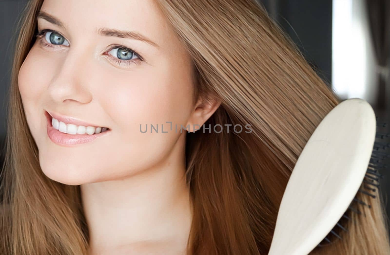 Beautiful happy woman combing her long hair.