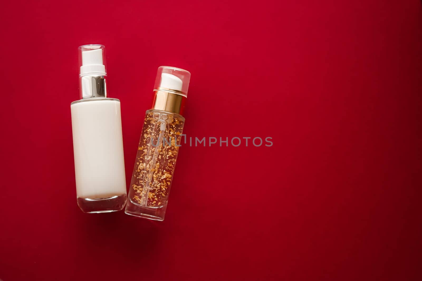 Skincare cosmetics and anti-aging beauty products, luxury skin care bottles, oil, serum and face cream on red background.