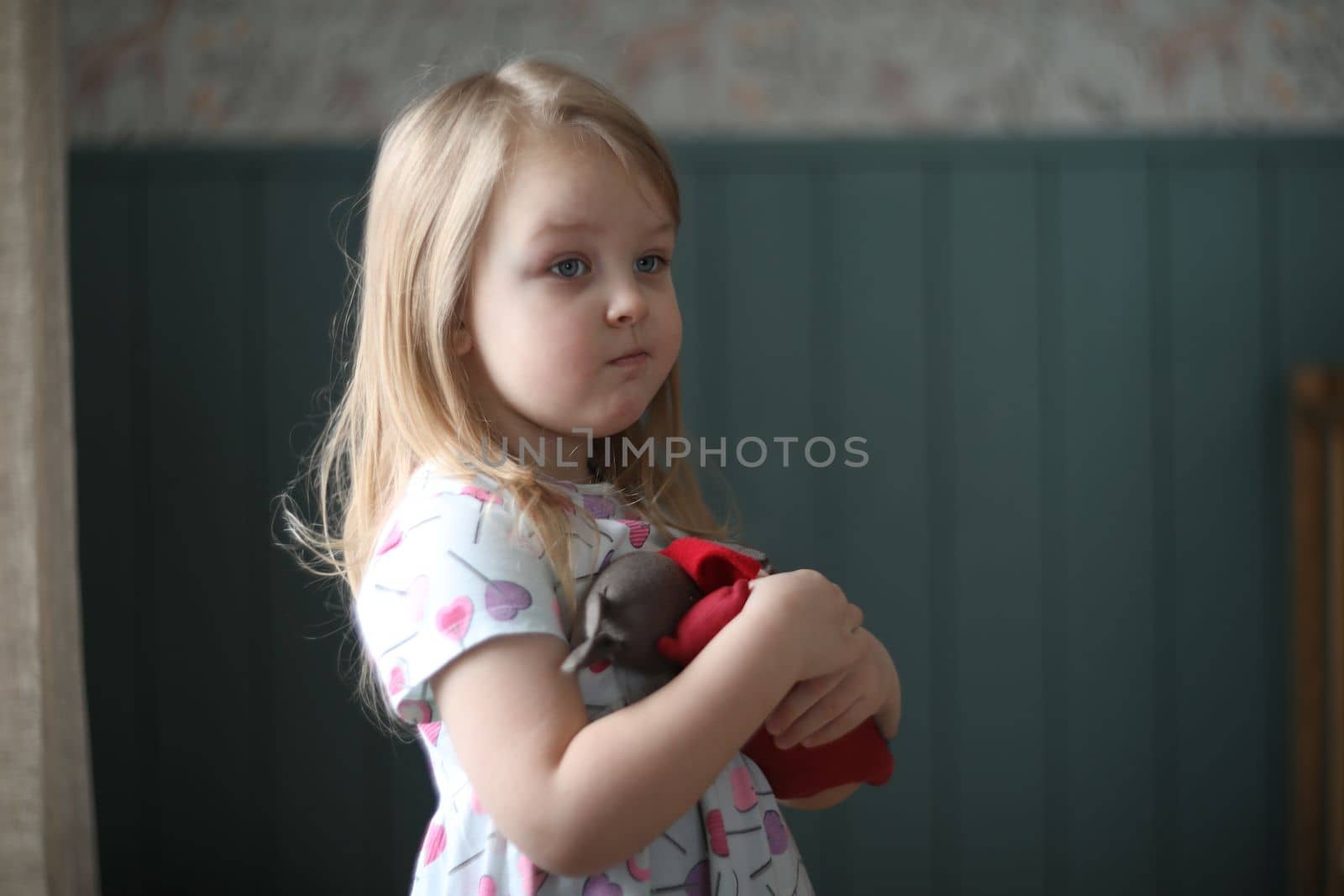 Portrait of a lovely little girl at home. Attractive lovely sweet curious cheerful smart toddler girl by paralisart