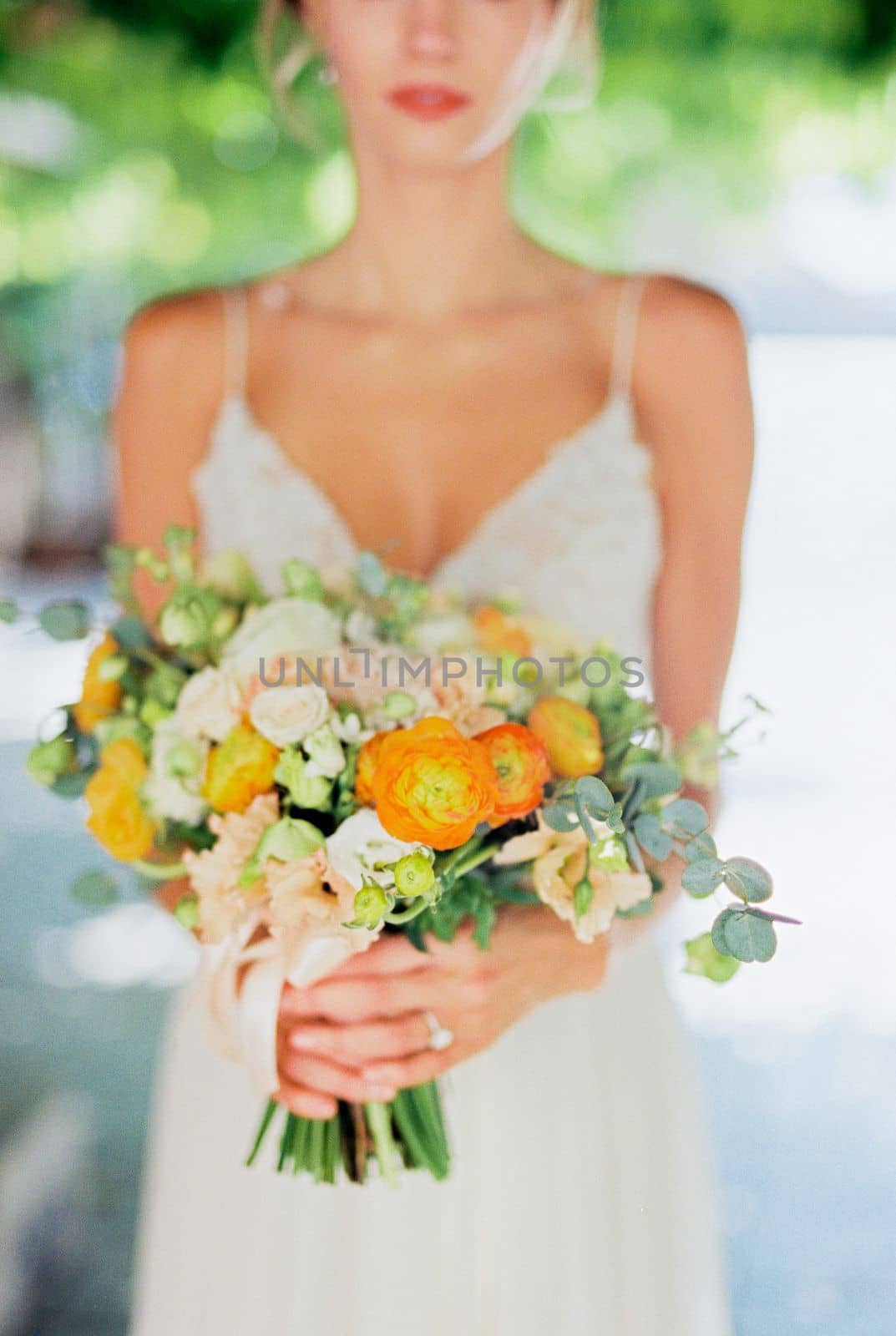 Bouquet of flowers in the hands of the bride. Cropped. High quality photo