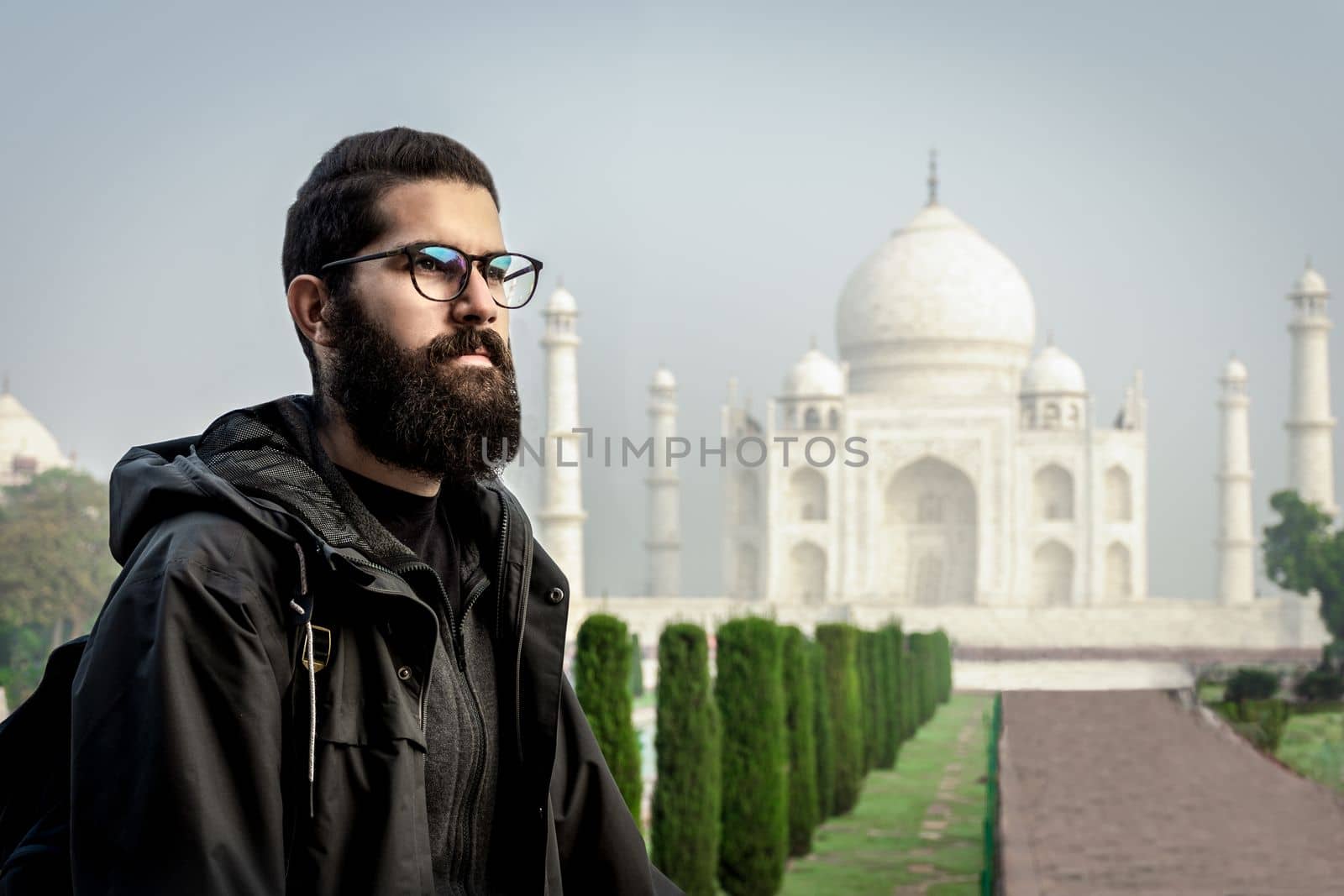 Young man in solo travel lifestyle having holiday in Taj Mahal, India by scasal15