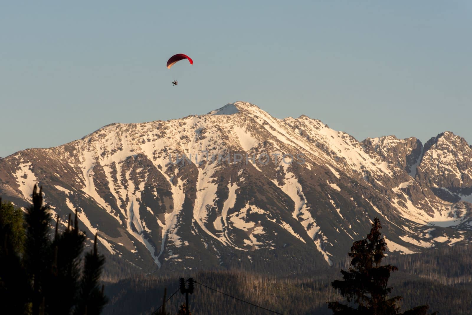 Tatra Mountains covered in snow with a paraglider. Panoramic view. High quality photo