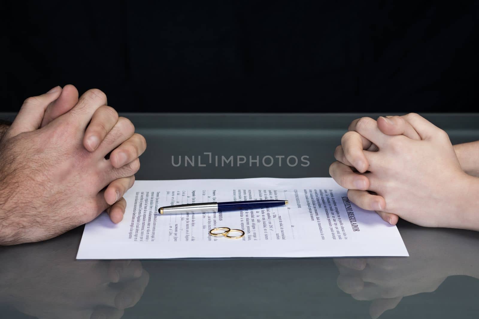 Couple goes through divorce signing papers. High quality photo