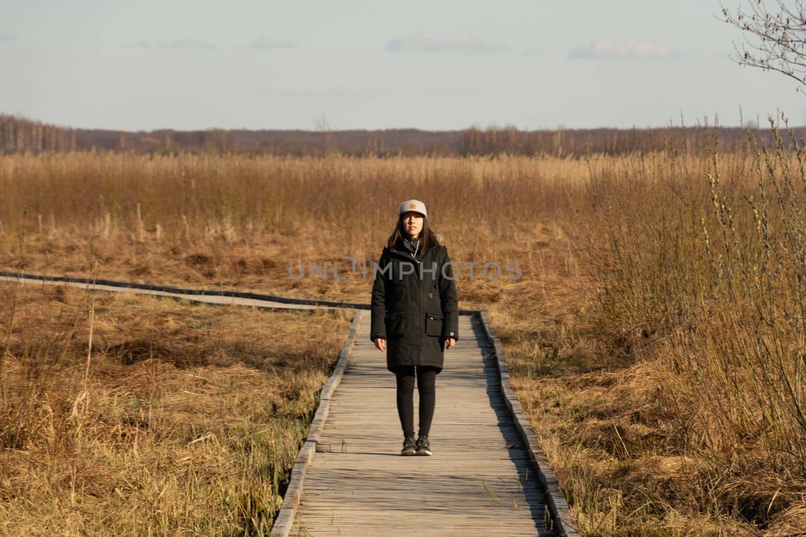 Young woman standing on a path in the middle of nature. High quality photo