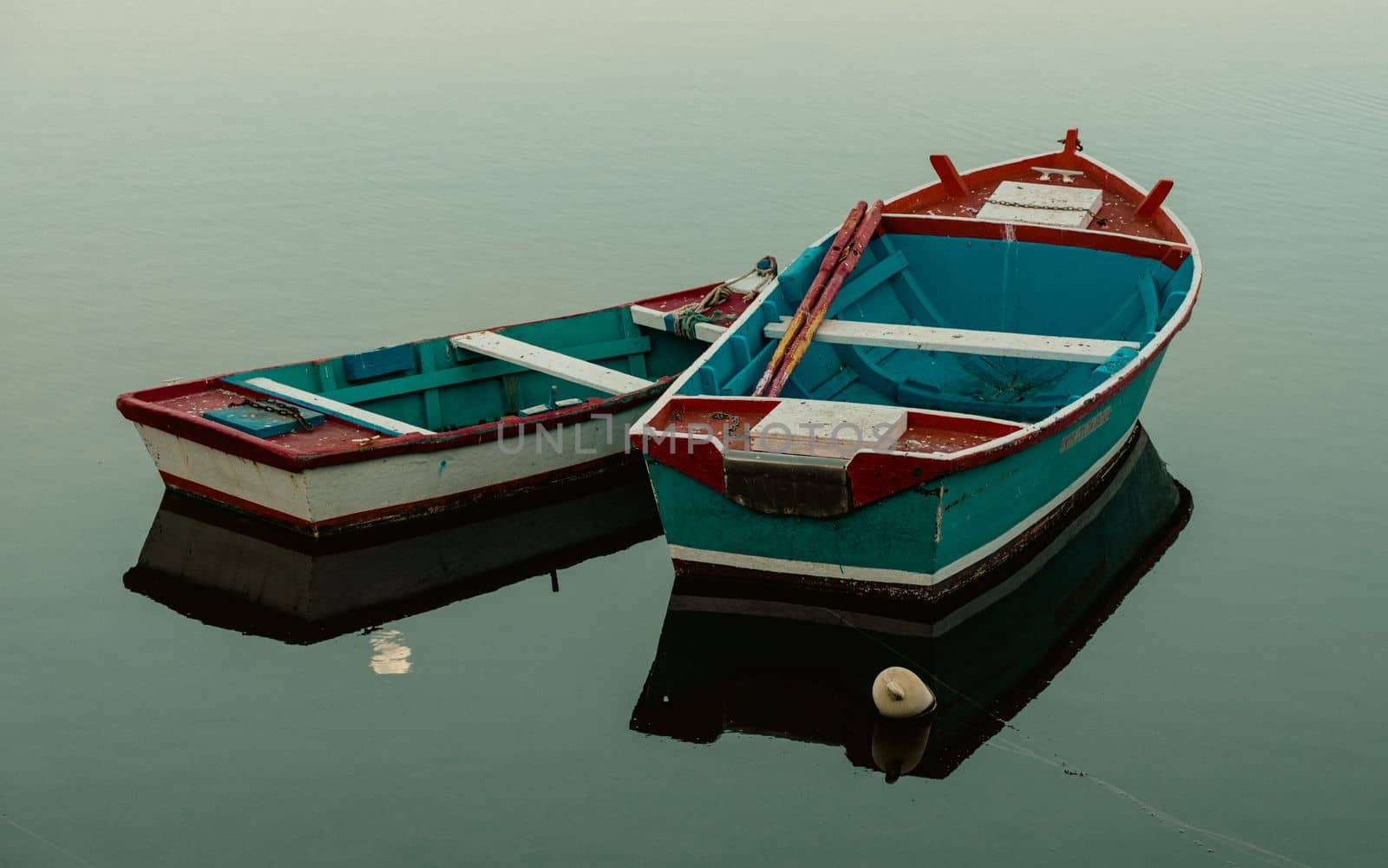 Small wooden boats on the water with reflections by scasal15