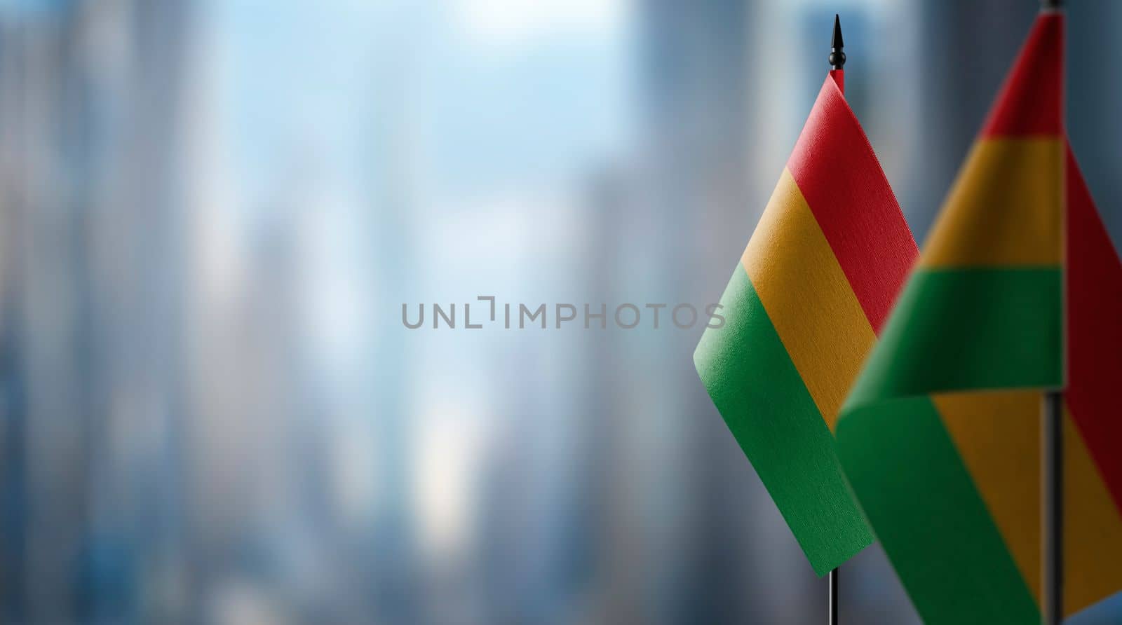 Small flags of the Bolivia on an abstract blurry background.