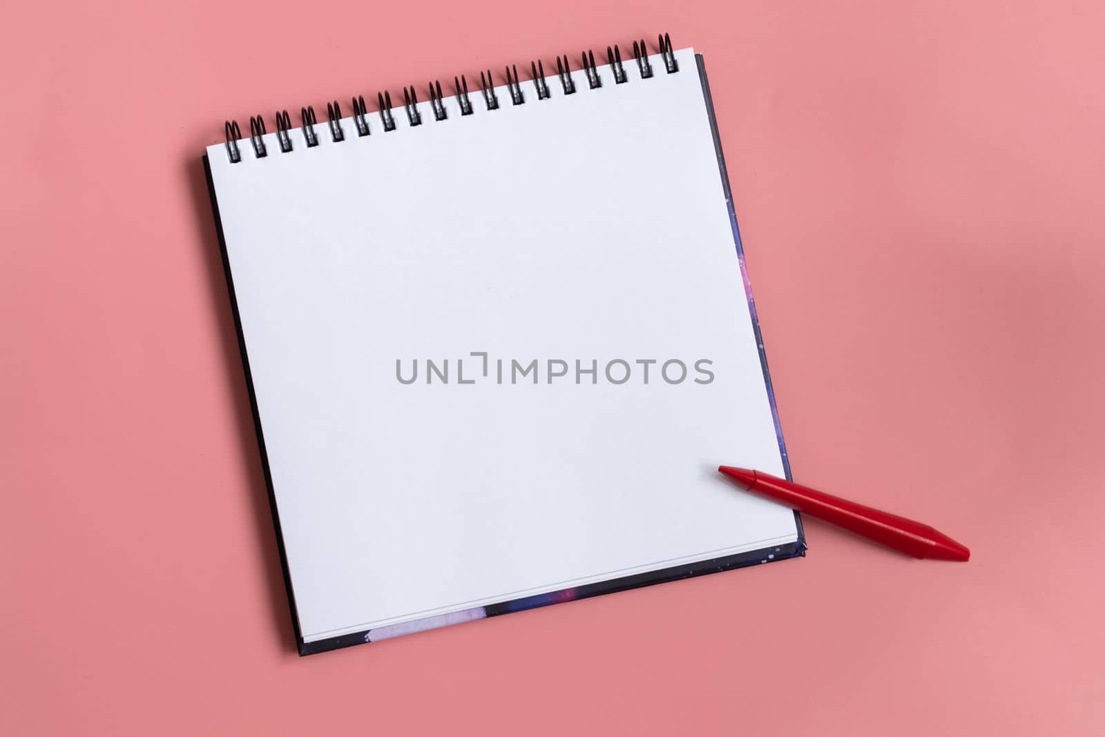 Mock up of empty scketchbook white paper on pastel pink background. One red wax crayon. Top view of open notebook with clean sheet. Copy space. by Ri6ka