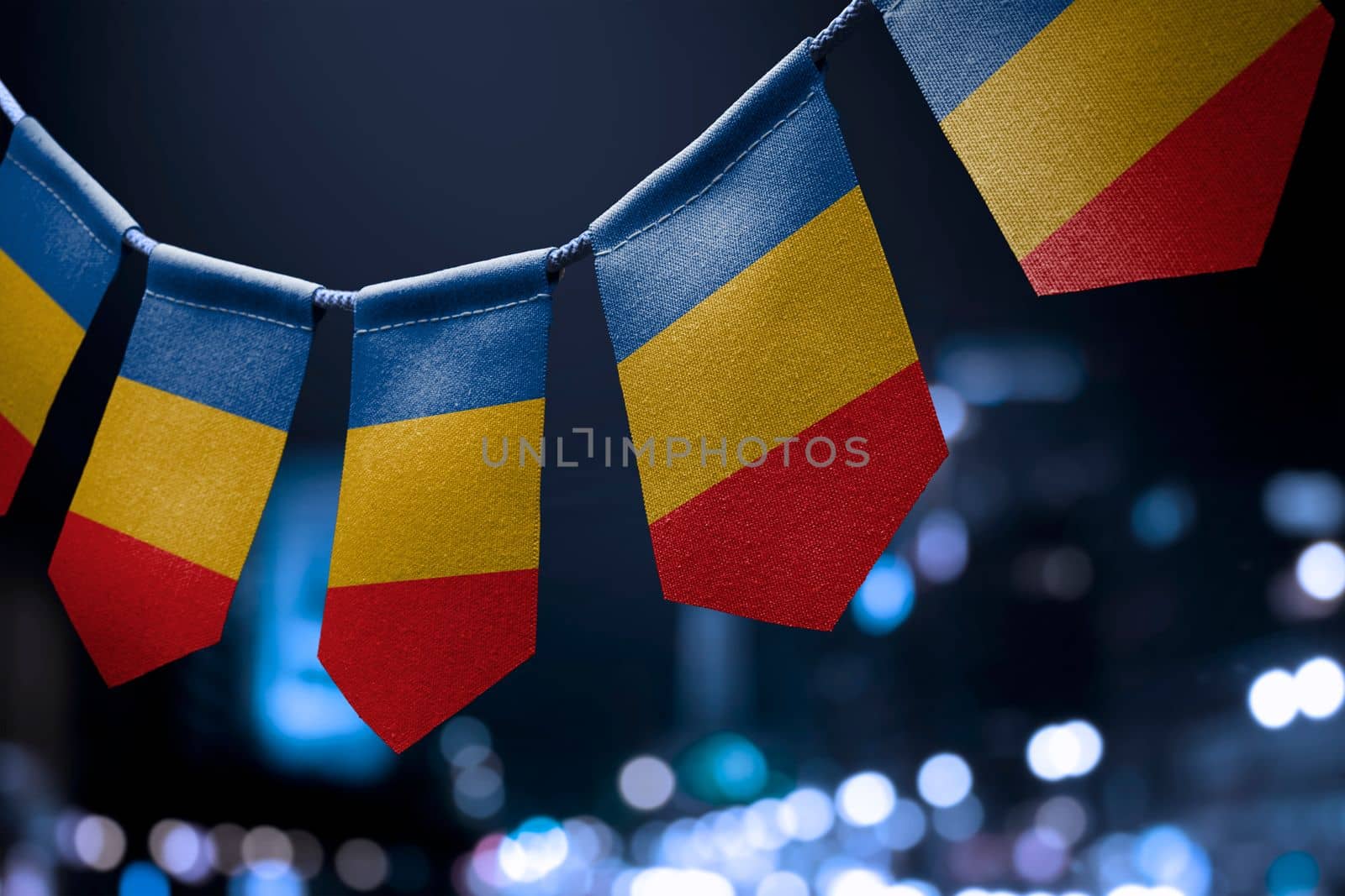 A garland of Chad national flags on an abstract blurred background.