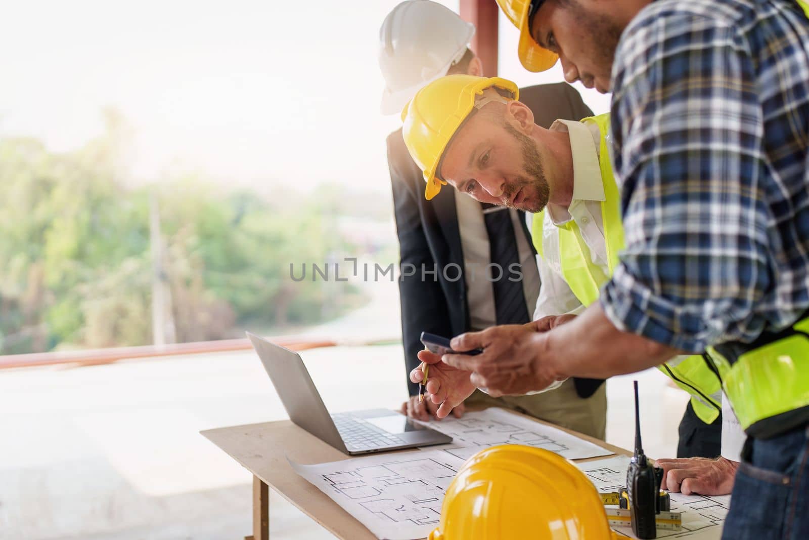 Civil Construction team working at renovate construction site. architectural plan, engineer sketching a construction project, green energy concept. by itchaznong