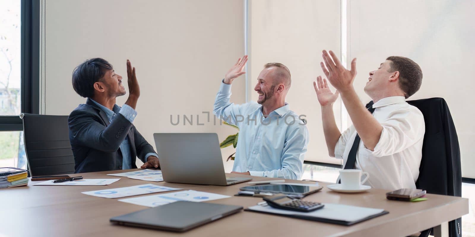 Group of Business people celebrate success in a meeting room. finance, achievement, strategy concept. by itchaznong