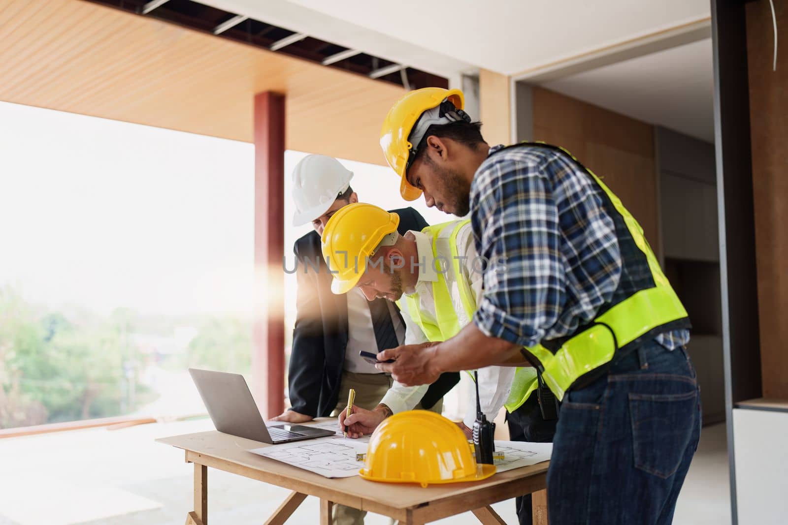 Civil Construction team working at renovate construction site. architectural plan, engineer sketching a construction project, green energy concept. by itchaznong