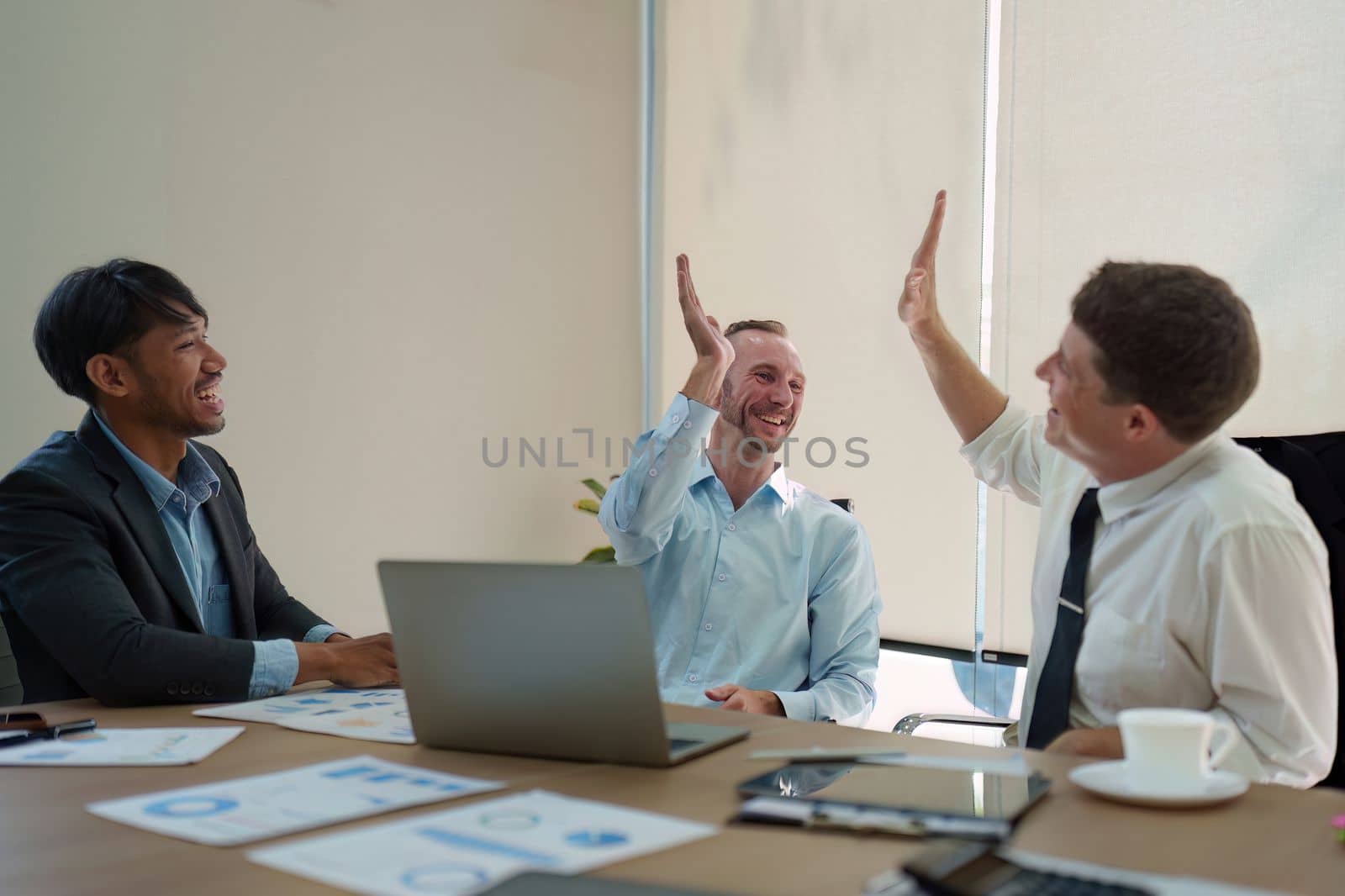 Group of Business people celebrate success in a meeting room. finance, achievement, strategy concept. by itchaznong