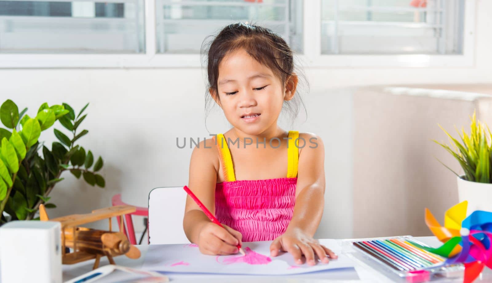 Asian cute kid preschool smiling draw creative hearts love picture at home, Happy child little girl colorful drawing pink heart on white paper, Valentine day or Mother or Fathers Day, art education