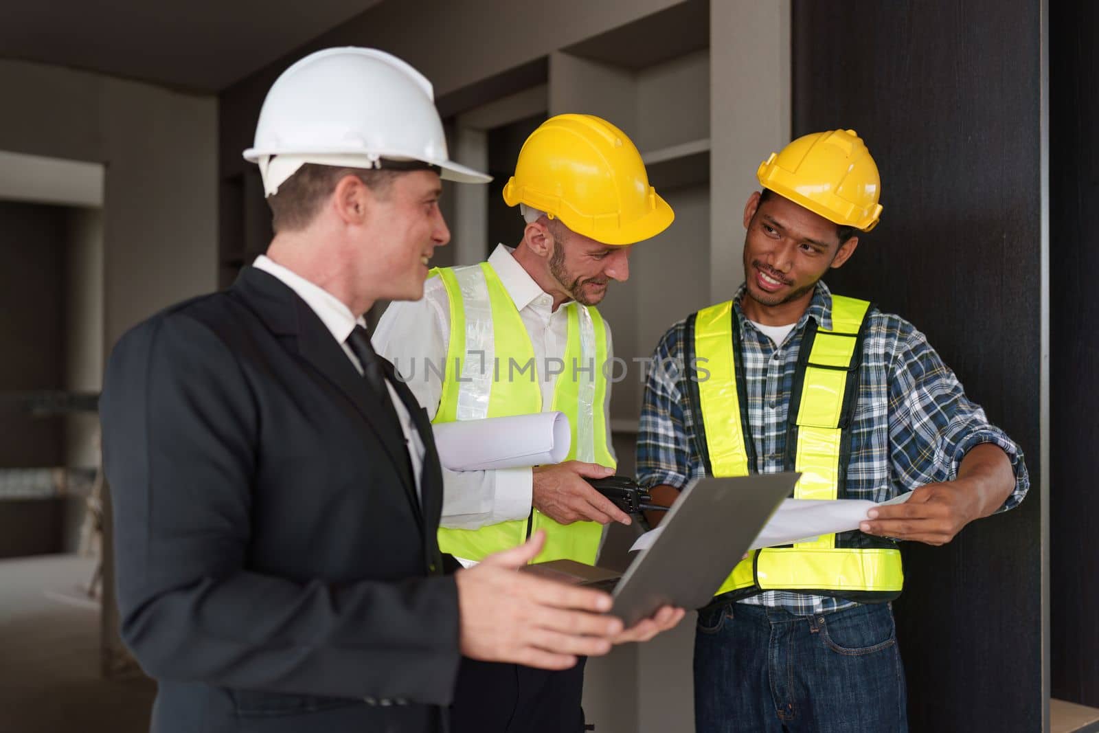 Civil Construction team working at renovate construction site. architectural plan, engineer sketching a construction project, green energy concept. by itchaznong