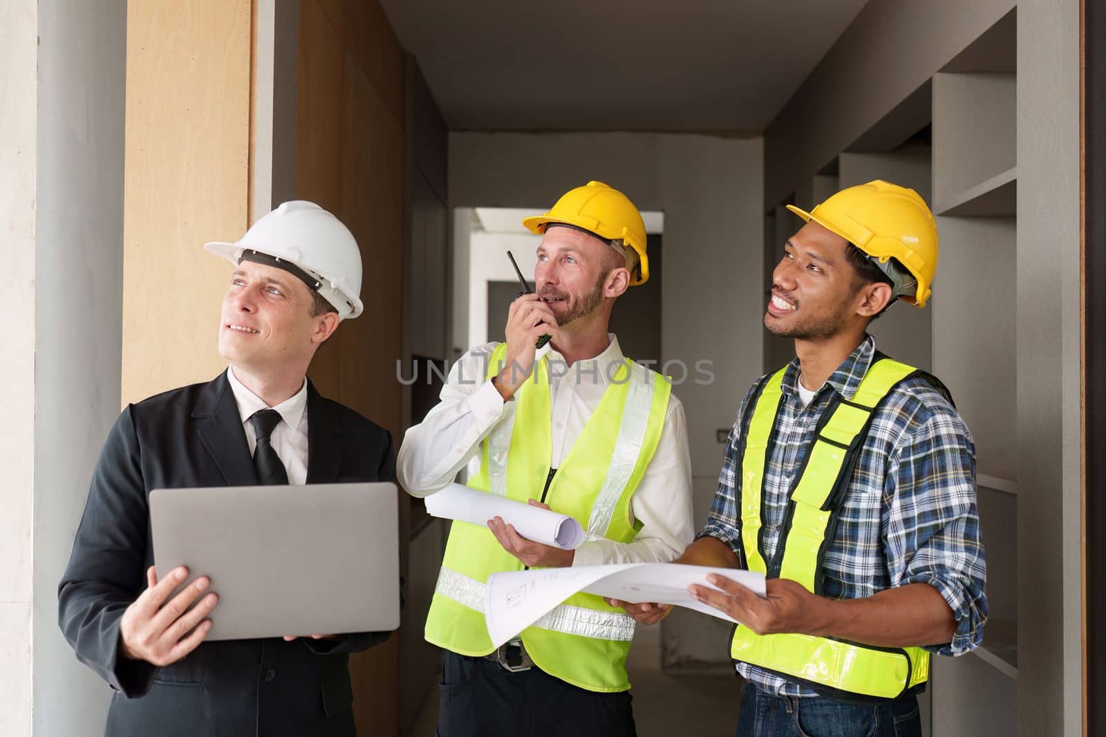 Civil Construction team working at renovate construction site. architectural plan, engineer sketching a construction project, green energy concept. by itchaznong