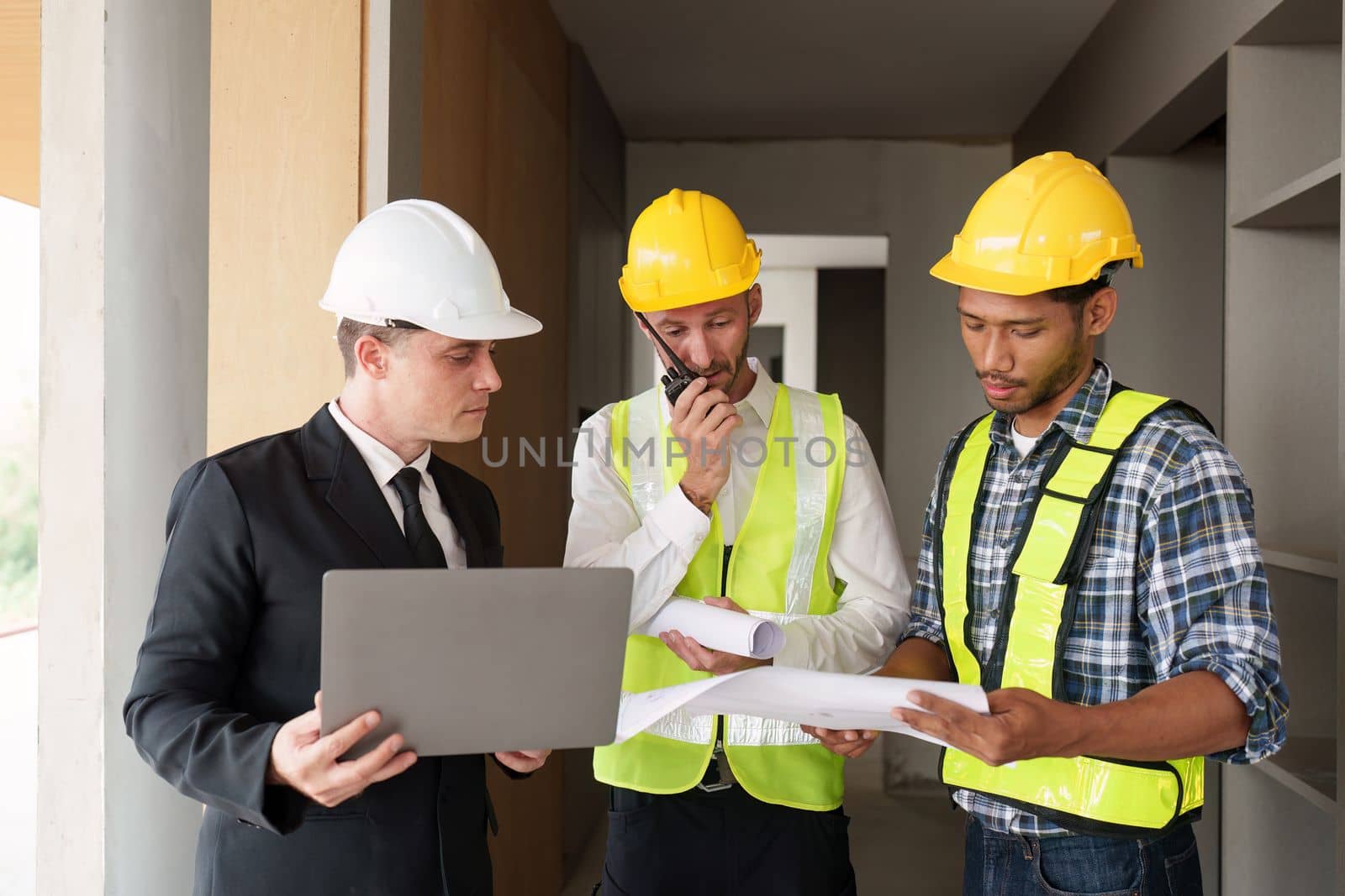 Civil Construction team working at renovate construction site. architectural plan, engineer sketching a construction project, green energy concept. by itchaznong