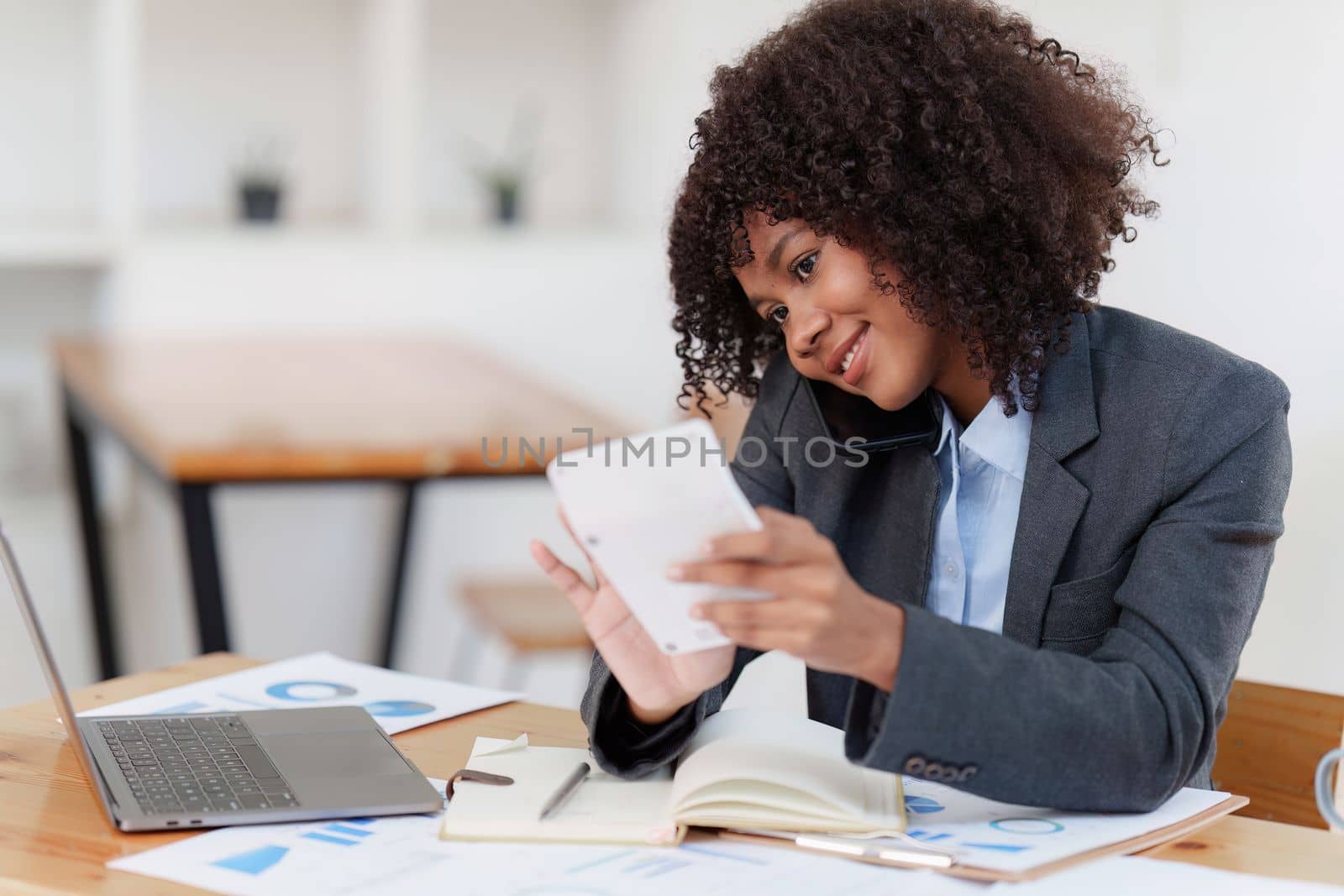 American african business woman talking on the mobile phone. Management, planning and networking phone call concept