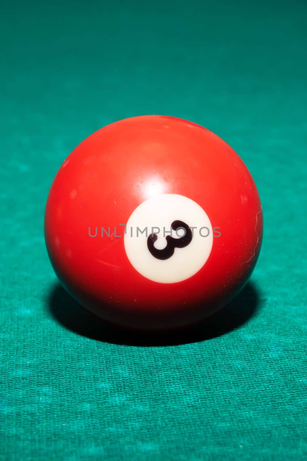 Billiard ball on a green table close up