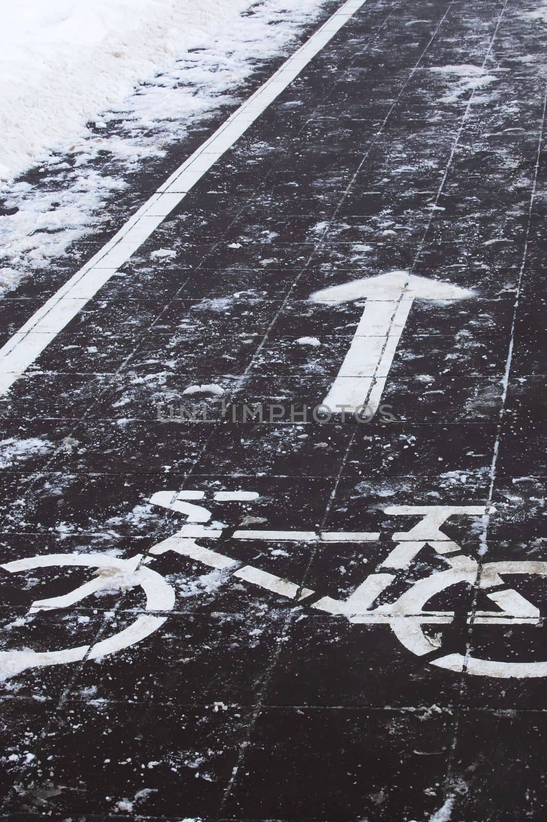 Symbol of a bike path on the sidewalk in the snow