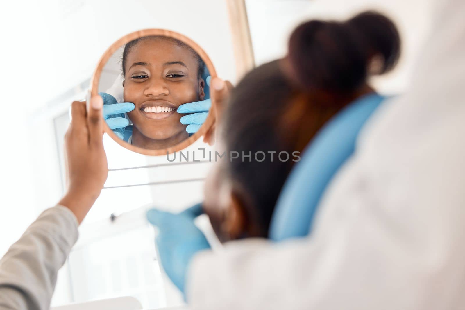 Flashing that million dollar smile. a young woman checking her dental work in a mirror
