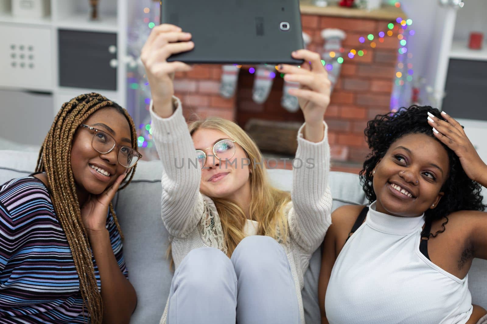 A shared selfie of college friends by a decorated fireplace. Christmas spent among friends from Africa and Europe.